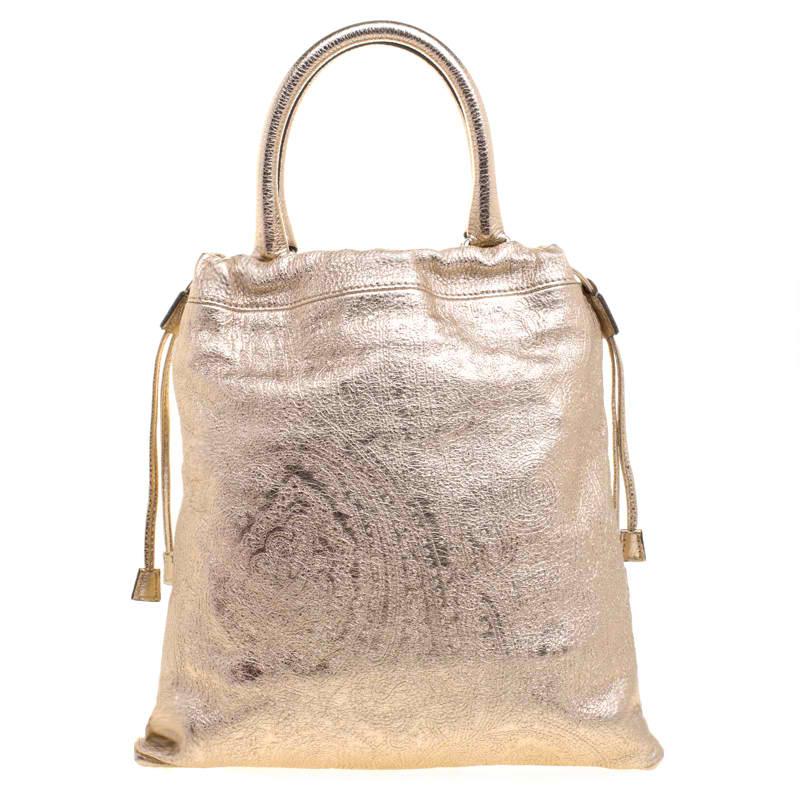 Etro is famous for prints, exceptional quality, and design. This metallic gold paisley printed tote is crafted from leather and comes with a canvas lined interior that will hold all your daily necessities. The bag is complete with dual handles and a