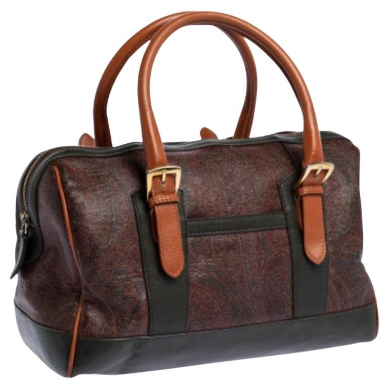 Fall in love almost instantly with this stunning handbag by Etro. This coated canvas and leather bag is found in the hands of celebrity divas across the world. The interior is styled with nylon exhibits its outstanding workmanship. Enhanced with