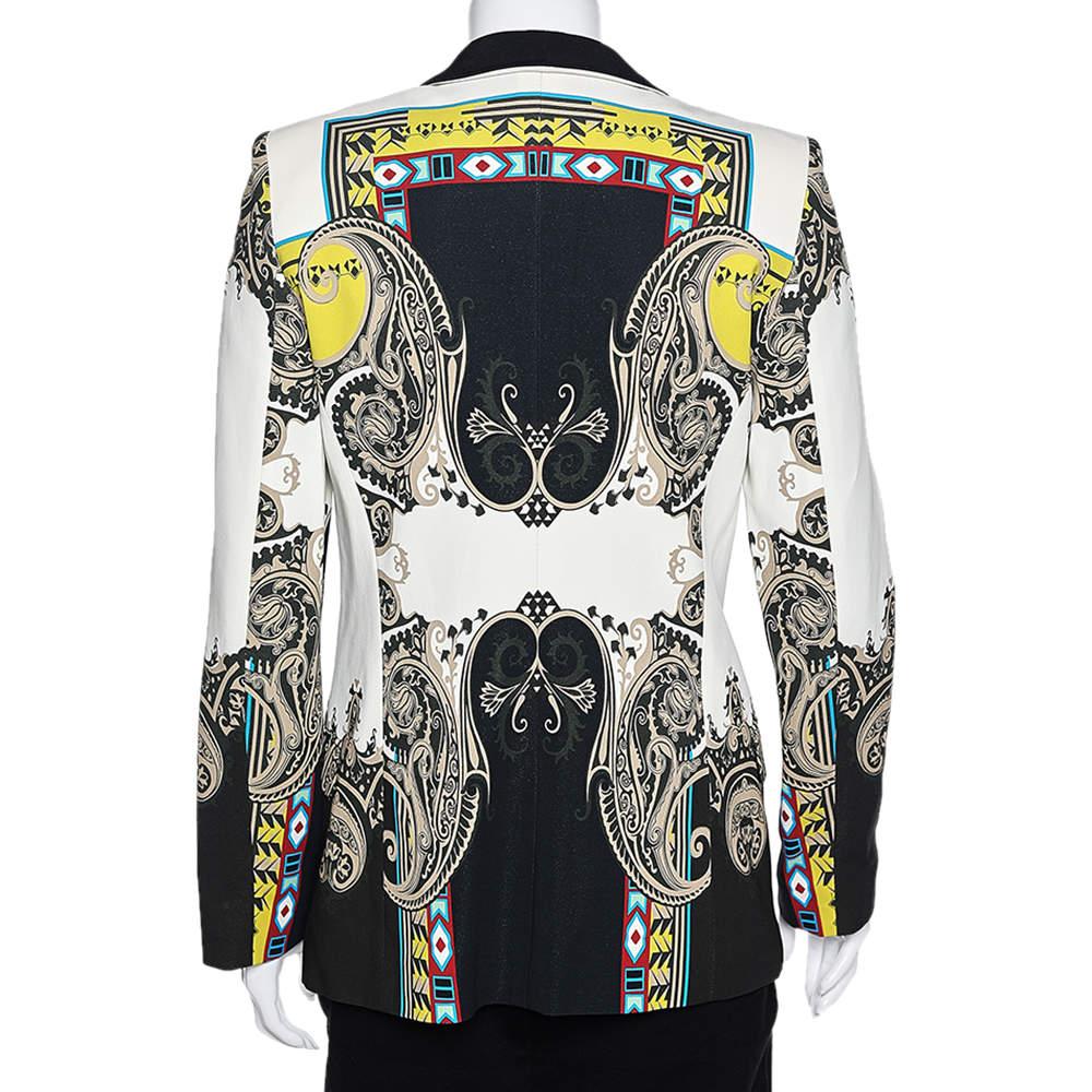 Etro's quaint aesthetics and quirky designs always make you look spectacular. This blazer from the House of Etro has been tailored intricately using multicolored printed crepe fabric and shows a button-front feature and long sleeves. Classy in style
