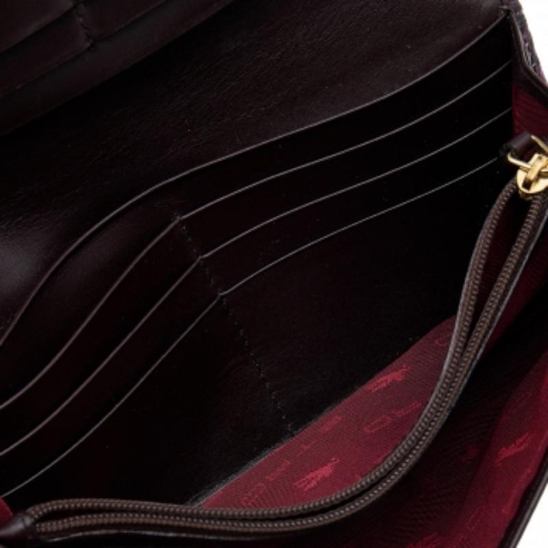 Made using python-effect leather, this continental wallet from Etro has a grand look and functional quality. The flap opens to a sleek interior featuring a zip pocket, open compartments, and card slots.