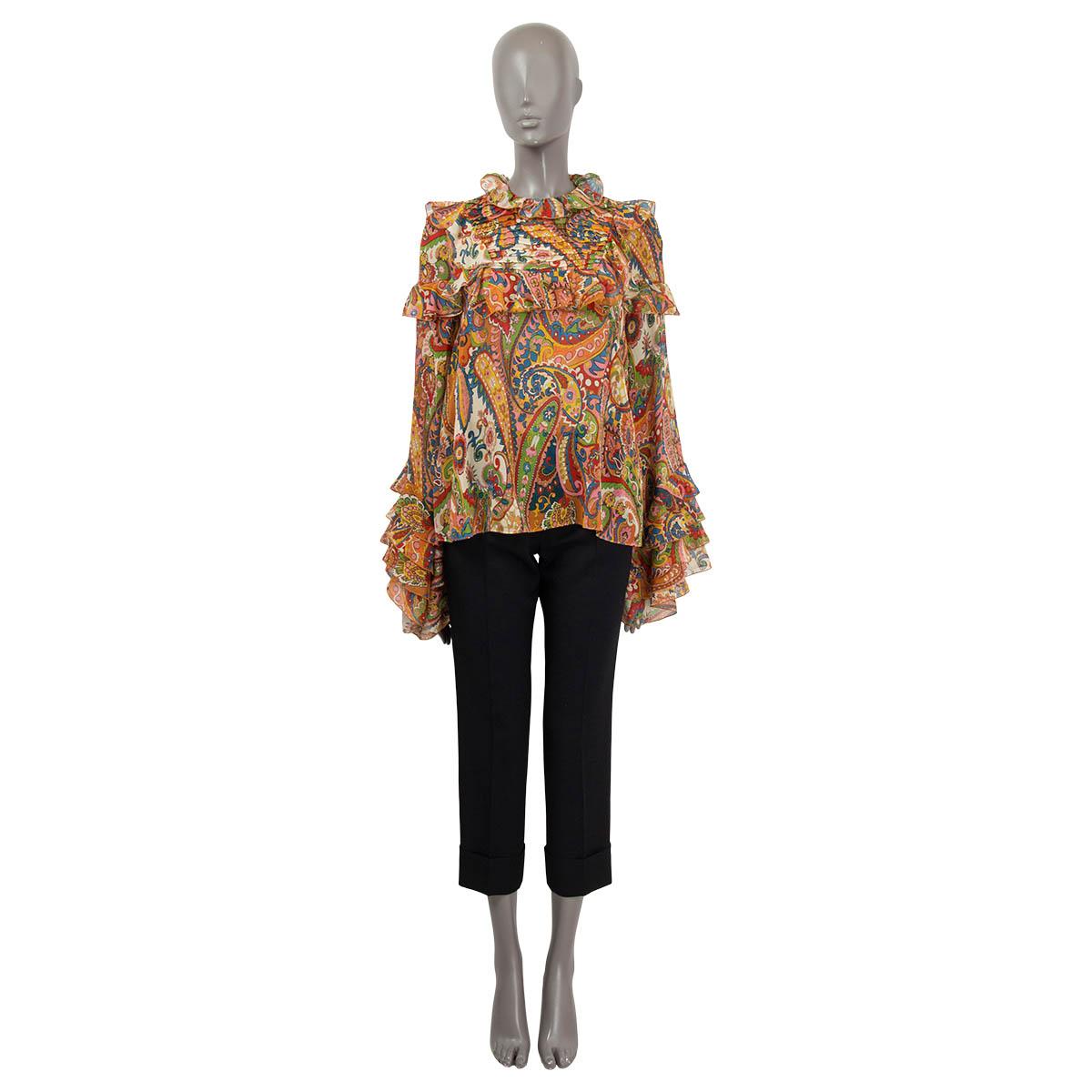100% authentic Etro California semi sheer blouse in orange, pink, blue, red, yellow and ivory silk (100%). Features flared cuffs, ruffled details and a paisley print. Opens with a button on the back. Unlined. Has been worn and is in excellent