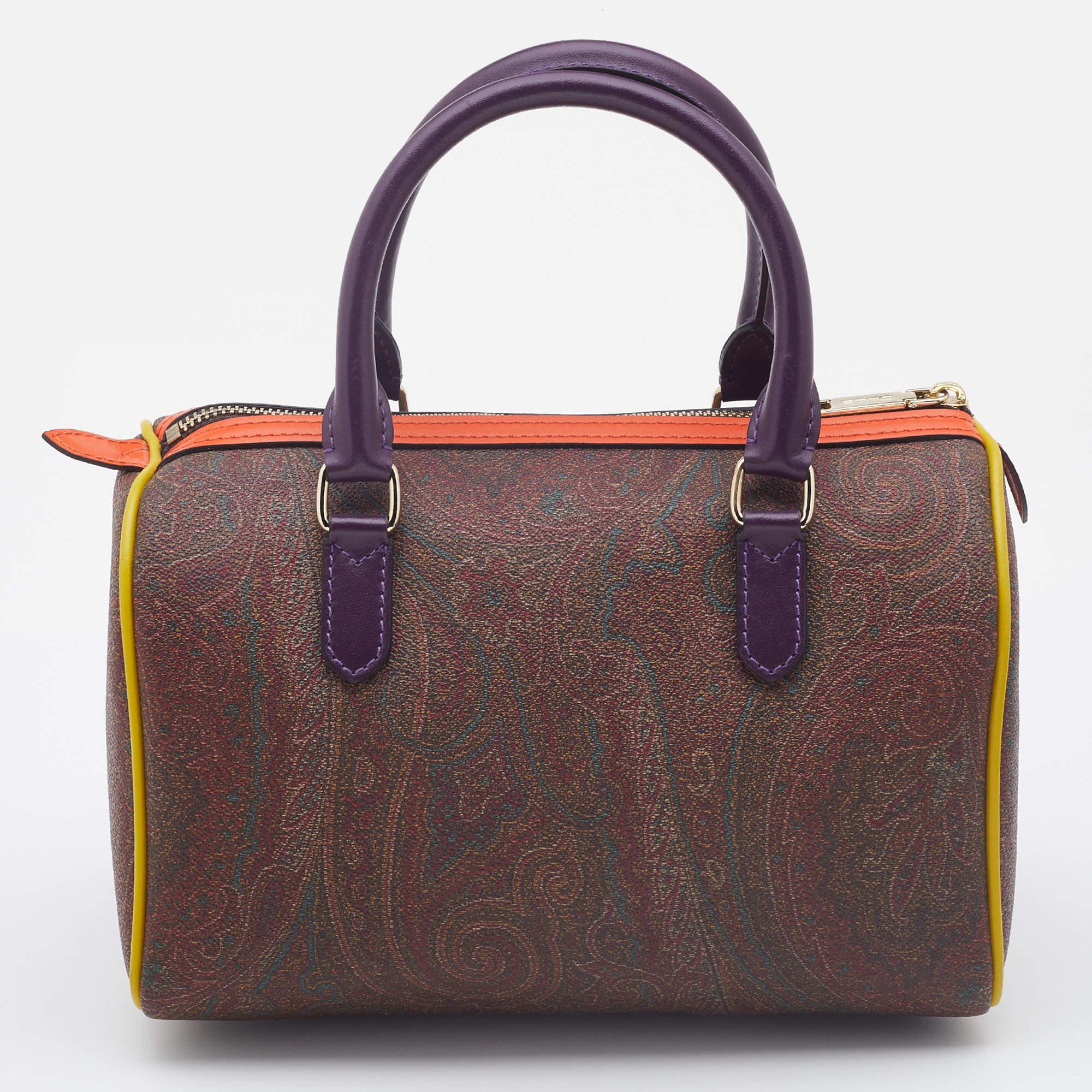 The Etro bowler bag is a stunning accessory that combines style and functionality. Its vibrant paisley print adds a touch of artistic flair, while the coated canvas and leather construction ensures durability. With its spacious interior and