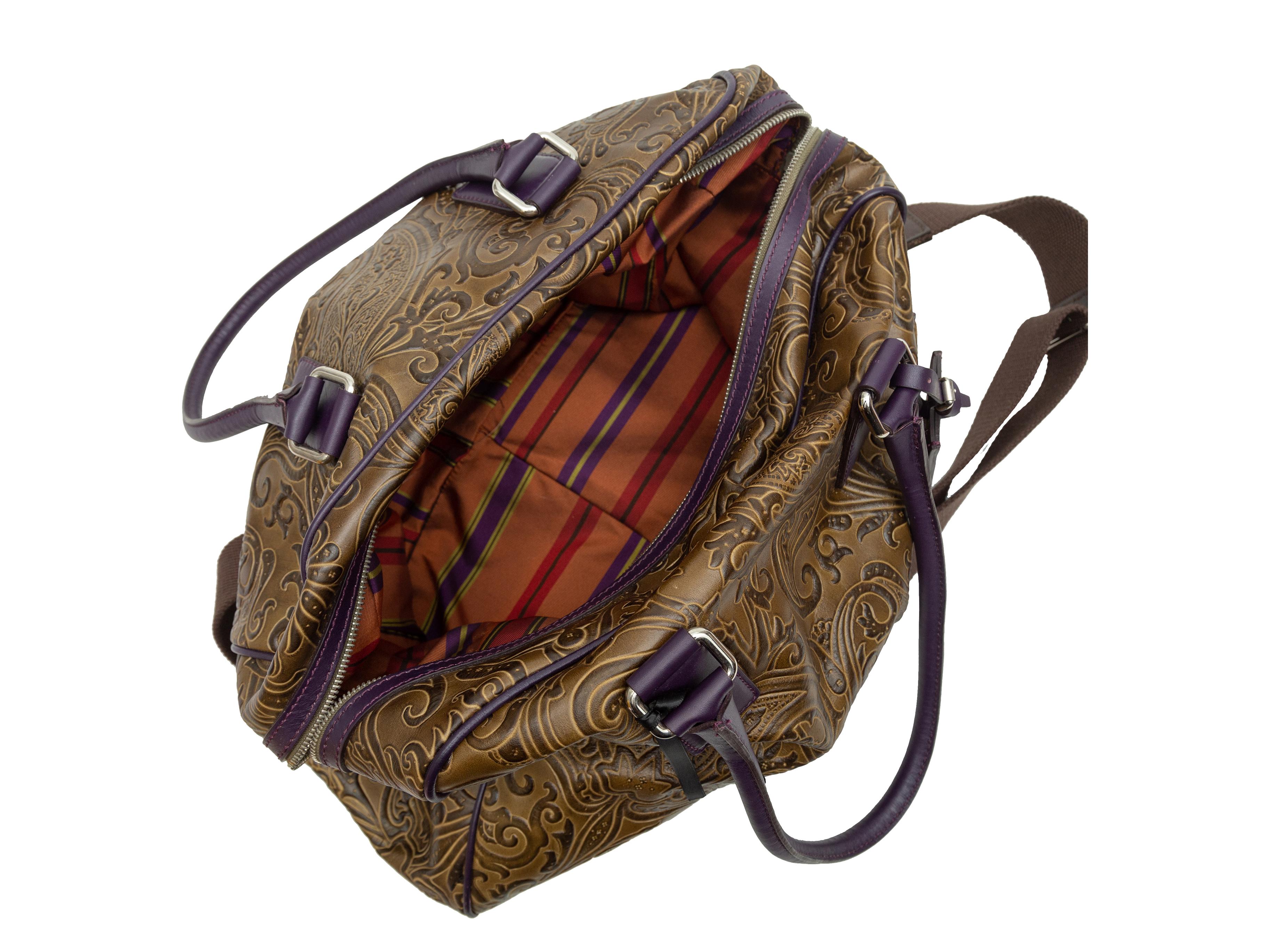 Product details: Olive green and dark purple tooled leather handbag by Etro. Paisley pattern throughout. Dual rolled top handles. Detachable shoulder strap. Zip closure at top. 16