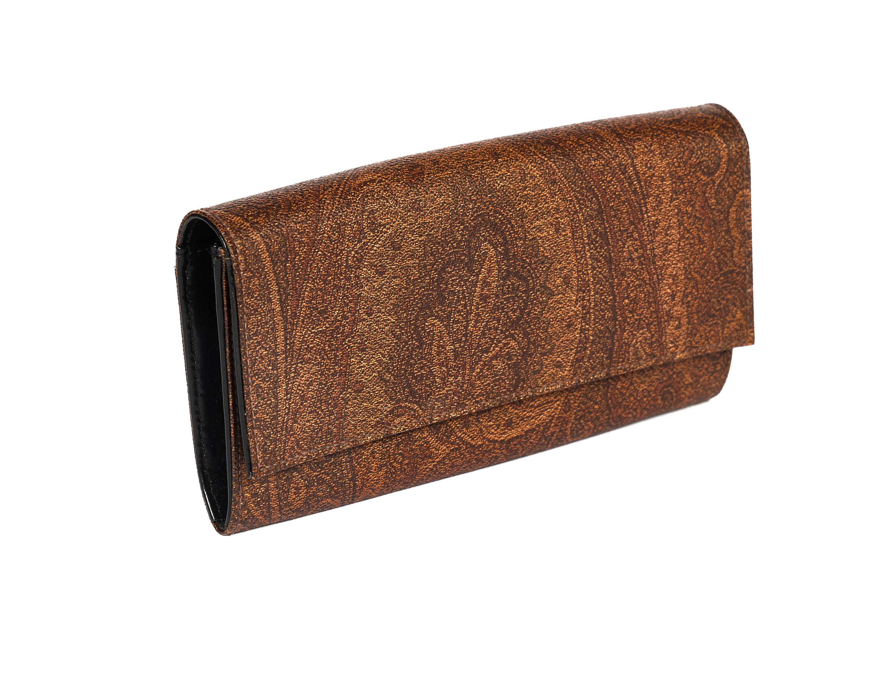Etro signature paisley coated canvas long wallet with black leather interior . Center zipped compartment. Very good condition.