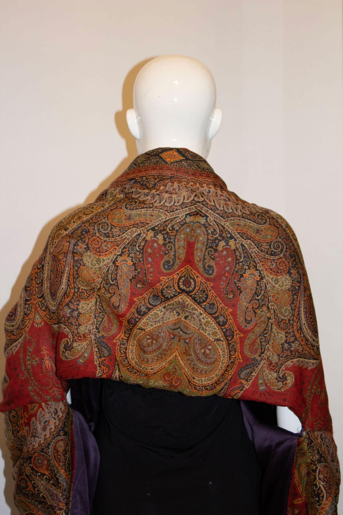 A wonderful shrug /cover up by Etro. In a pretty paisley design , the fabric is a wool and silk mix., with padding, is lined and has attractive tassle ties. 
Measurements: Bust up to 46'', length 17''