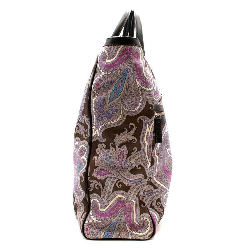 Etro Paisley Print Tote Bag 

This tote bag features double leather top handles, front leather logo patch detail, and an all over paisley pattern placement. On the interior there is one internal zip pocket and a phone pouch. The interior is lined