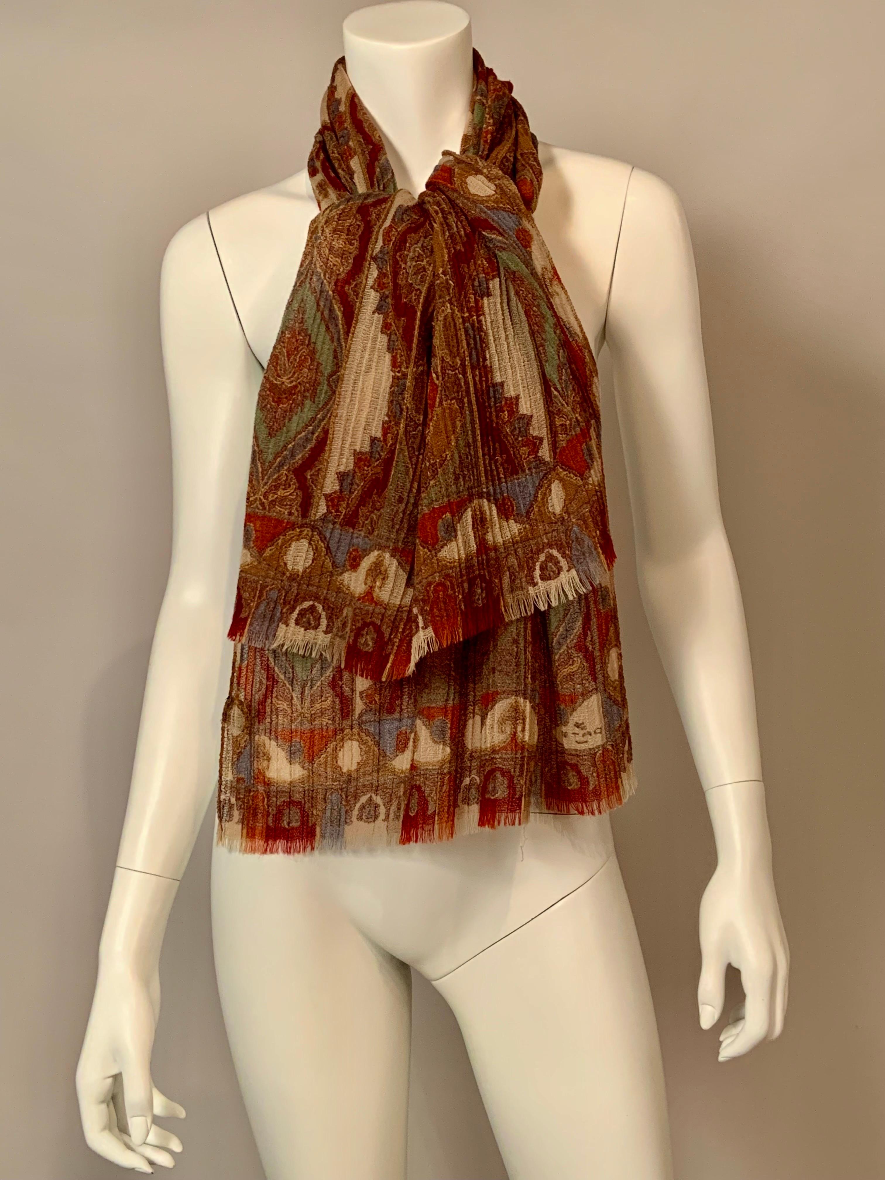 Etro is almost synonymous with paisley but they have managed to add extra interest to this piece by pleating the sheer wool fabric used for this scarf which can double as a shawl. There is a cream background with shades of blue, green, coral, taupe,