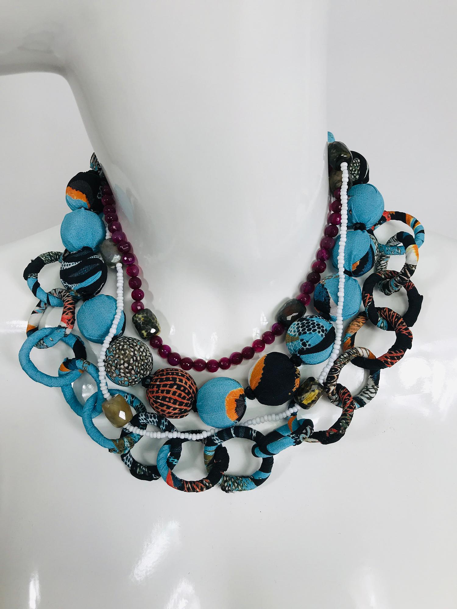Etro printed silk balls and loop links with glass beads and garnet coloured stone beads. This beautiful necklace has round balls and loop links that are covered in Etro print silk fabric, there are two beaded necklace intertwined one in white glass