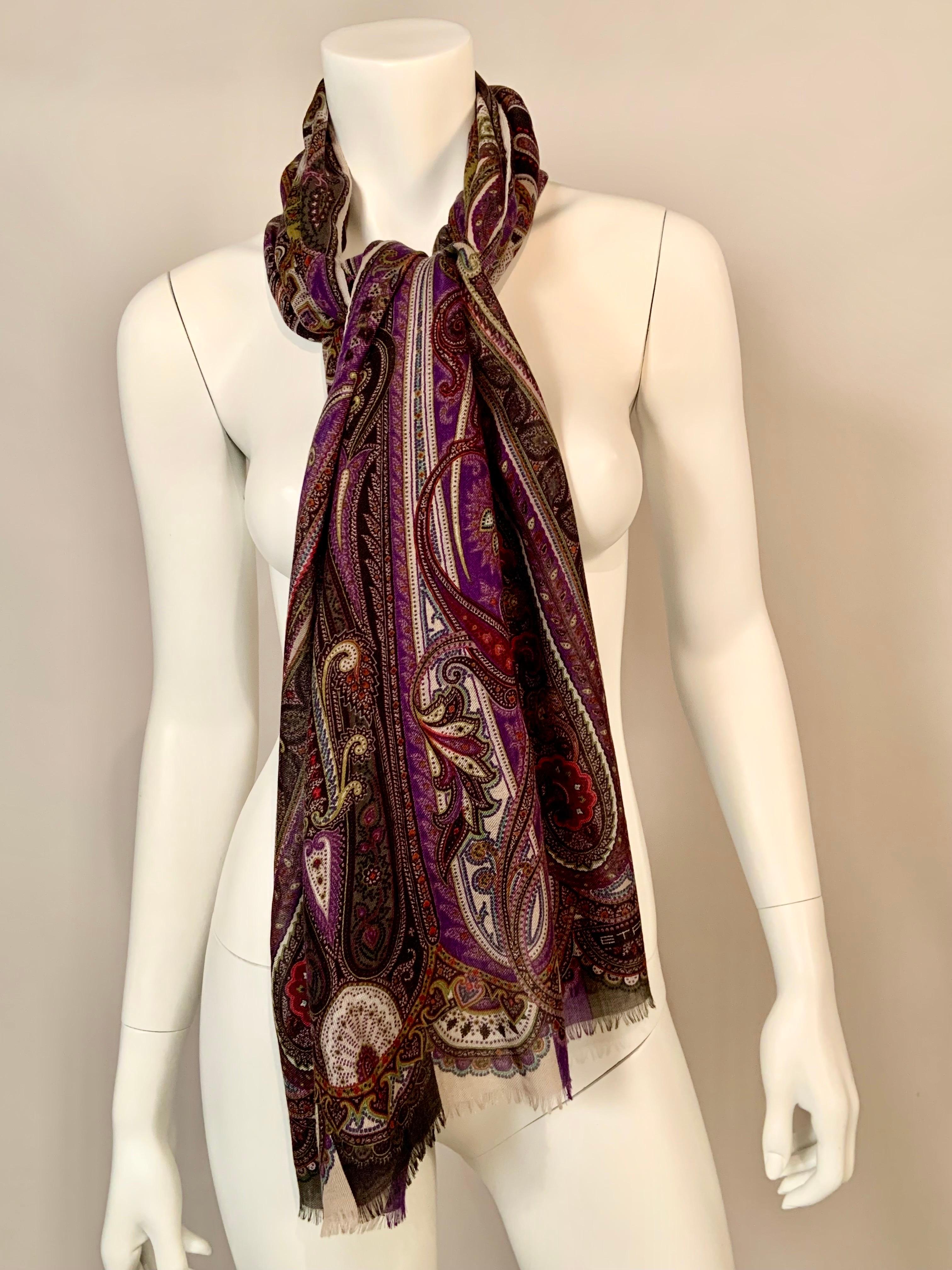 This colorful paisley patterned wool and silk scarf from Etro, Milano has a white center with chartreuse panels and paisley designs in shades purple, olive, lavender, chartreuse and white. It is marked Etro in the design on one corner and also bears