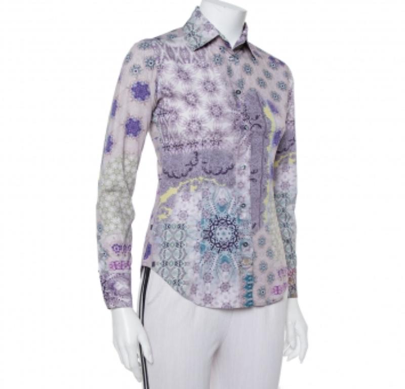 Effortlessly stylish and feminine, this Etro shirt is great for casual days. Crafted from cotton, it carries a lovely purple hue and flaunts interesting prints throughout. It has a fitted silhouette, long sleeves, a collar, and a button front. It