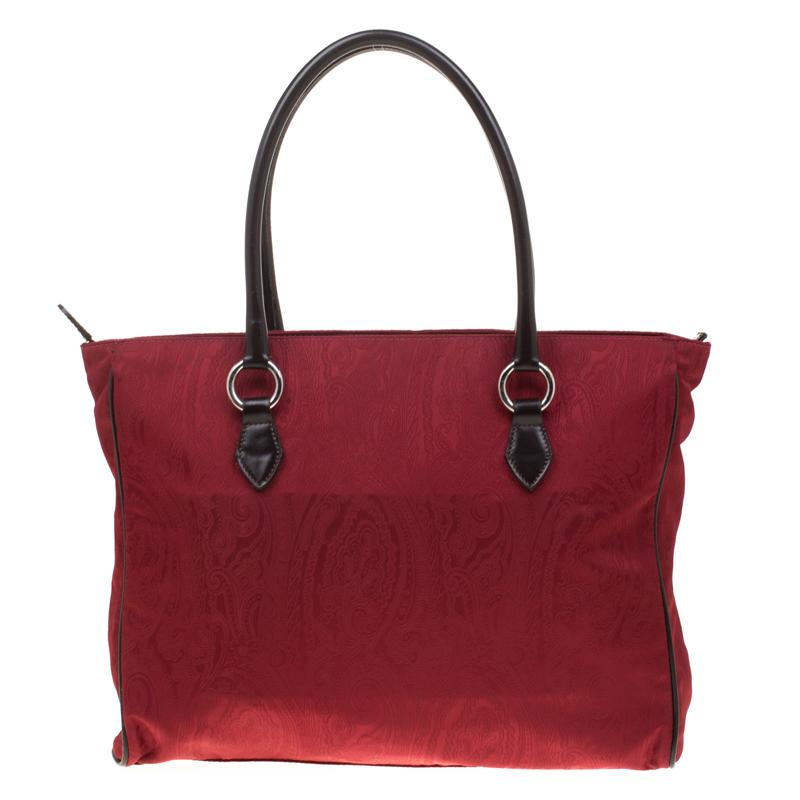 Keep it classy with this bag from the house of Etro. Add a touch of sophistication to your outfit by carrying this dressy and chic canvas accessory. Its interior canvas lining ensures that your valuables are kept safe and handy. This red beauty will