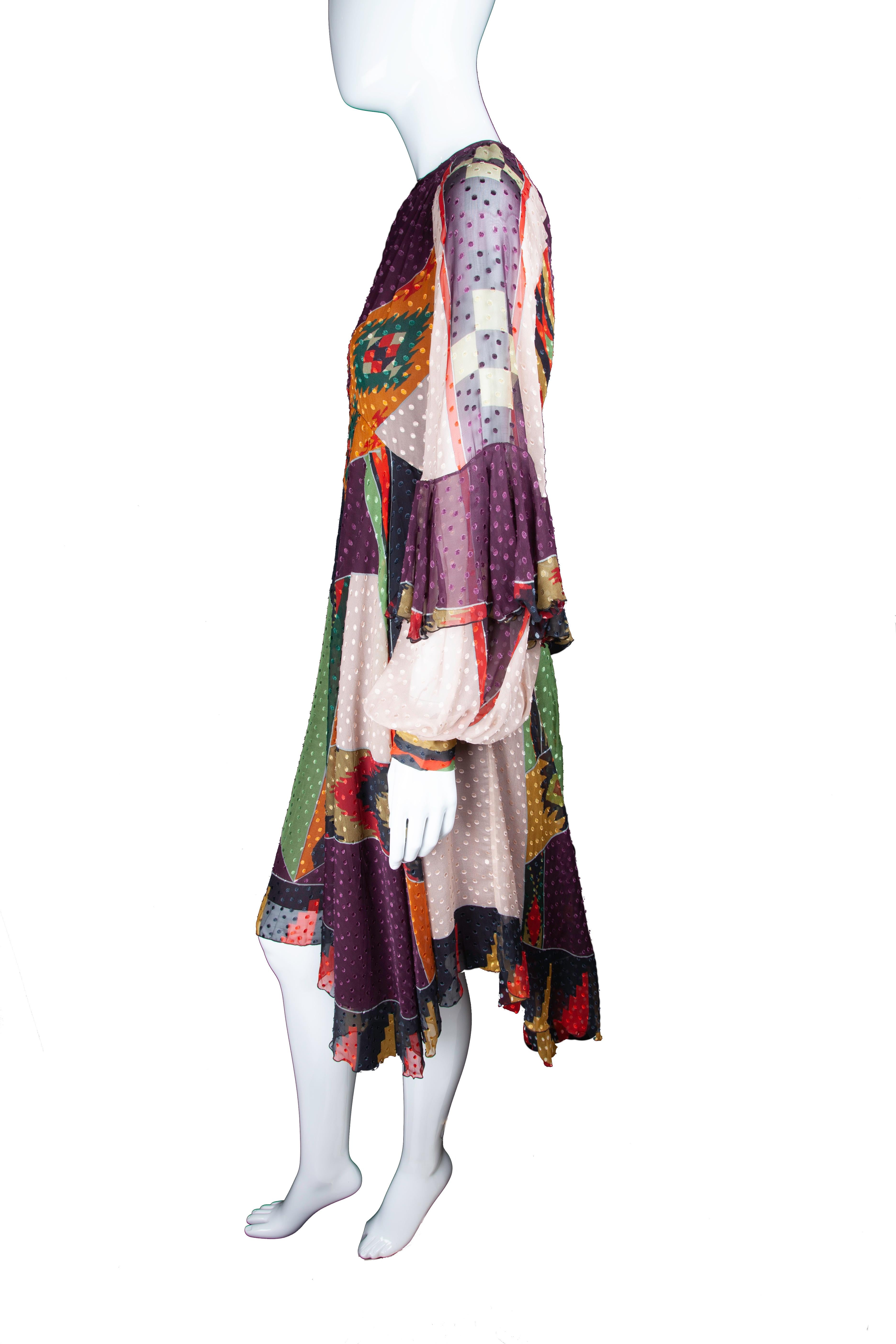 This Fall 2018 Runway Etro dress features long, balloon sleeves, a Native American inspired multicolor print, a fitted waist, flare skirt, and midi length. The dress also includes a sash that can be tied around the waist or worn as a scarf. Brand