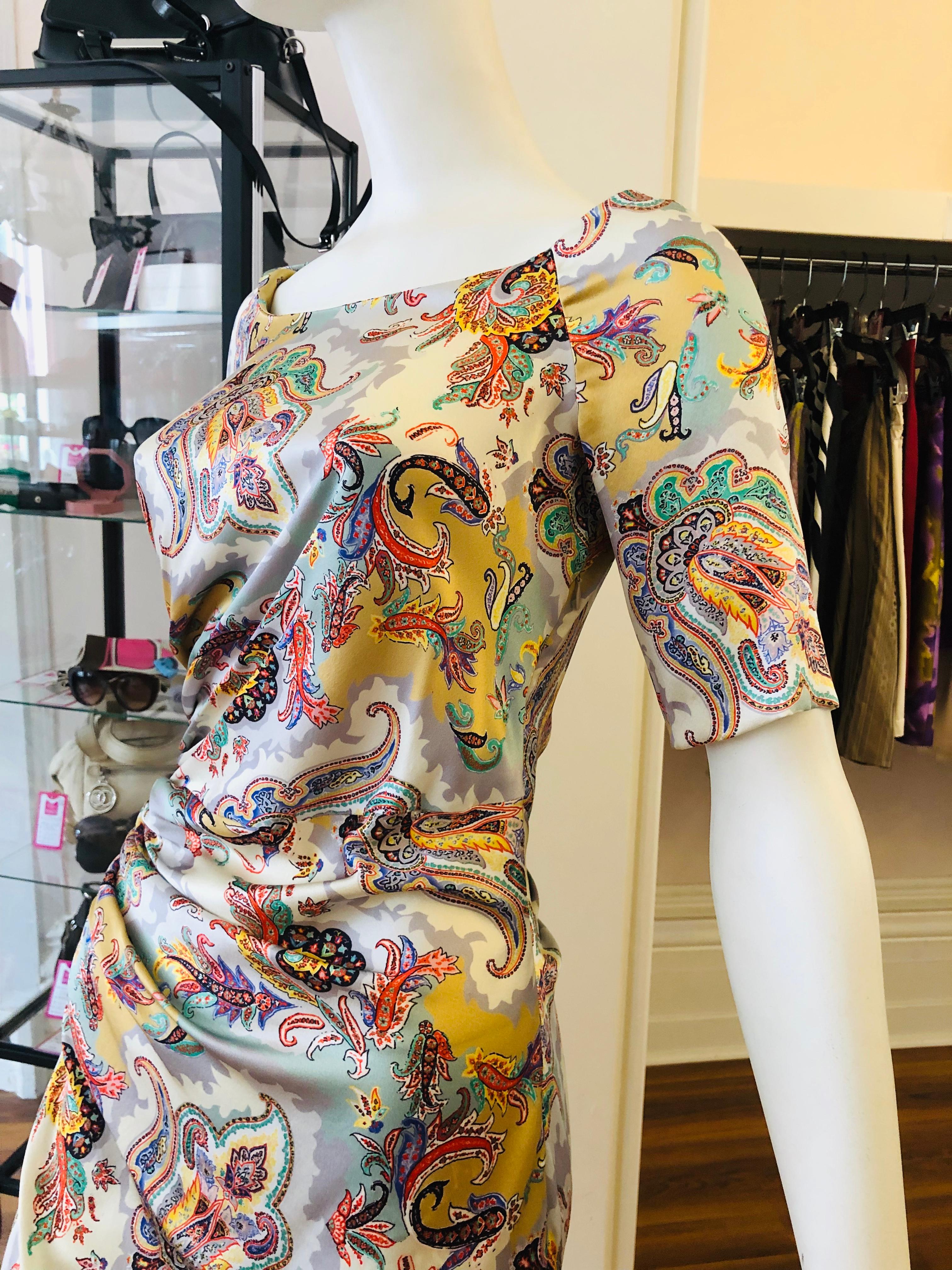 ETRO silk dress with 7% elasthane which give it some stretch. There is side draping on both the front and back and the colors go from silver to green, orange and gold. This dress is very versatile as it can be worn from day to night.
There is an