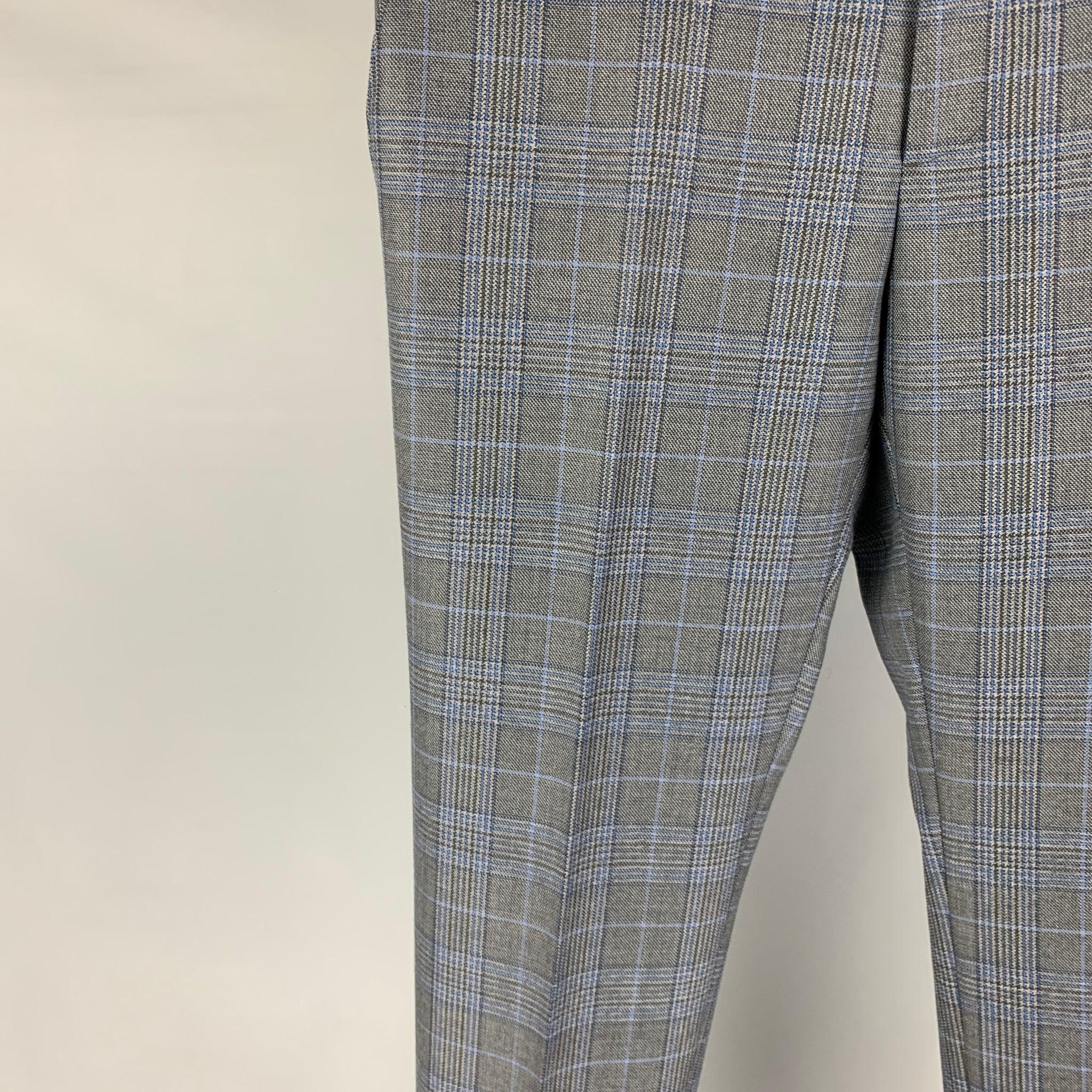 ETRO dress pants comes in a grey & blue plaid wool featuring a flat front, slim fit, and a zip fly closure. Made in Italy.
Excellent
Pre-Owned Condition. 

Marked:   48 

Measurements: 
  Waist: 32 inches Rise: 10 inches Inseam: 34 inches Leg