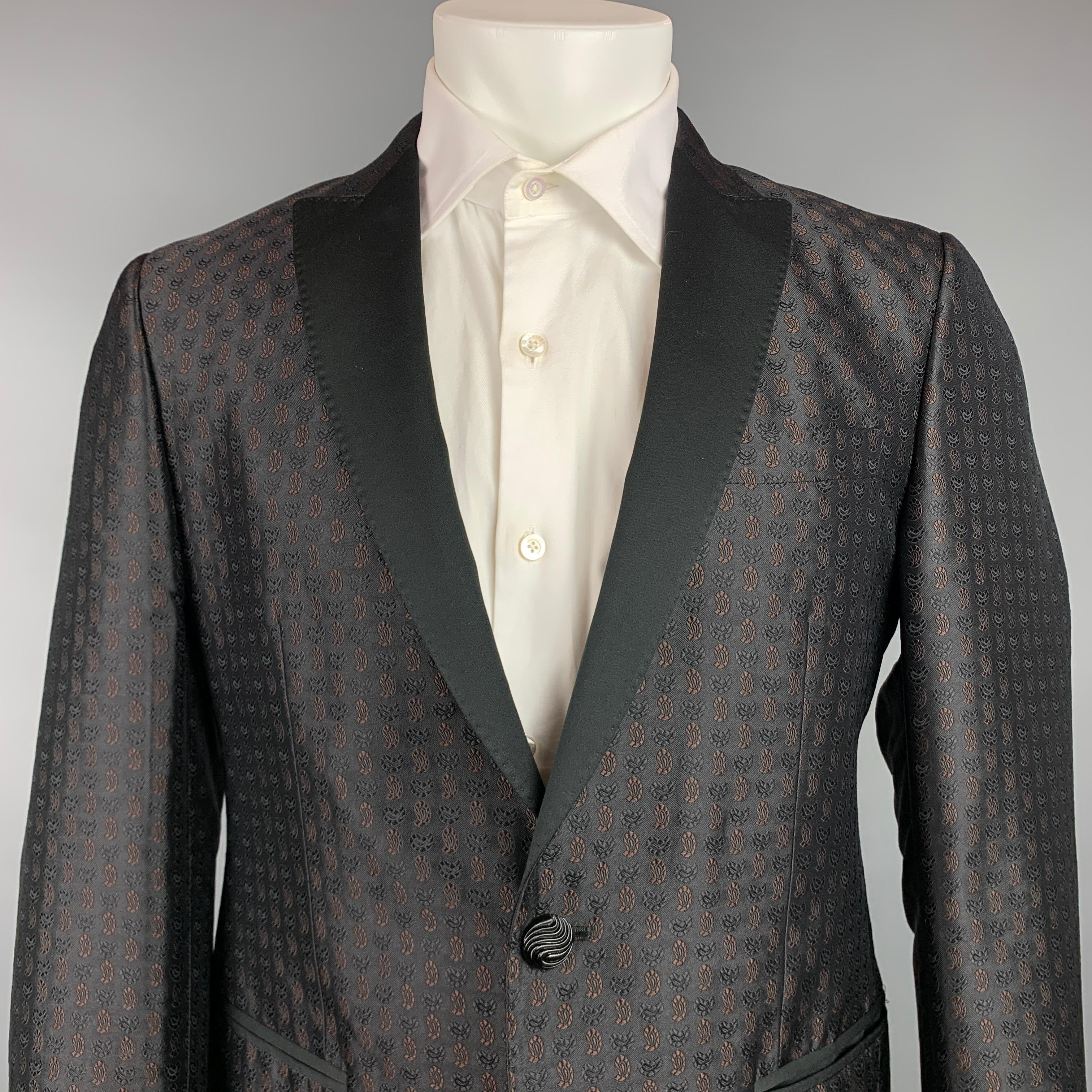 ETRO sport coat comes in a black & brown jacquard silk blend with a full liner featuring a peak lapel, slit pockets, and a single button closure. Made in Italy.

Very Good Pre-Owned Condition.
Marked: 48

Measurements:

Shoulder: 17.5 in.
Chest: 38