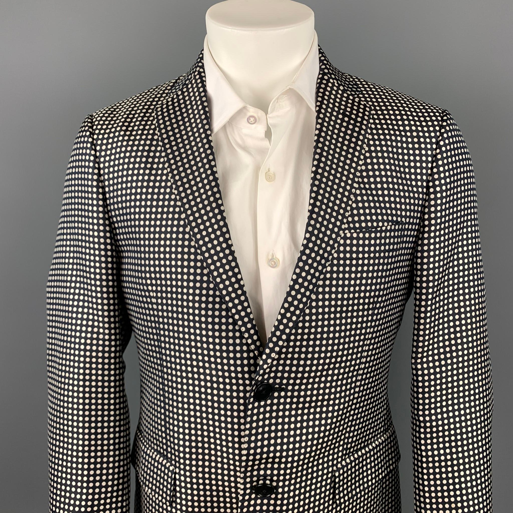 ETRO sport coat comes in a black & white polka dot silk with a full liner featuring a notch lapel, flap pockets, and a two button closure. Made in Italy.

Very Good Pre-Owned Condition.
Marked: IT 48

Measurements:

Shoulder: 17.5 in.
Chest: 38