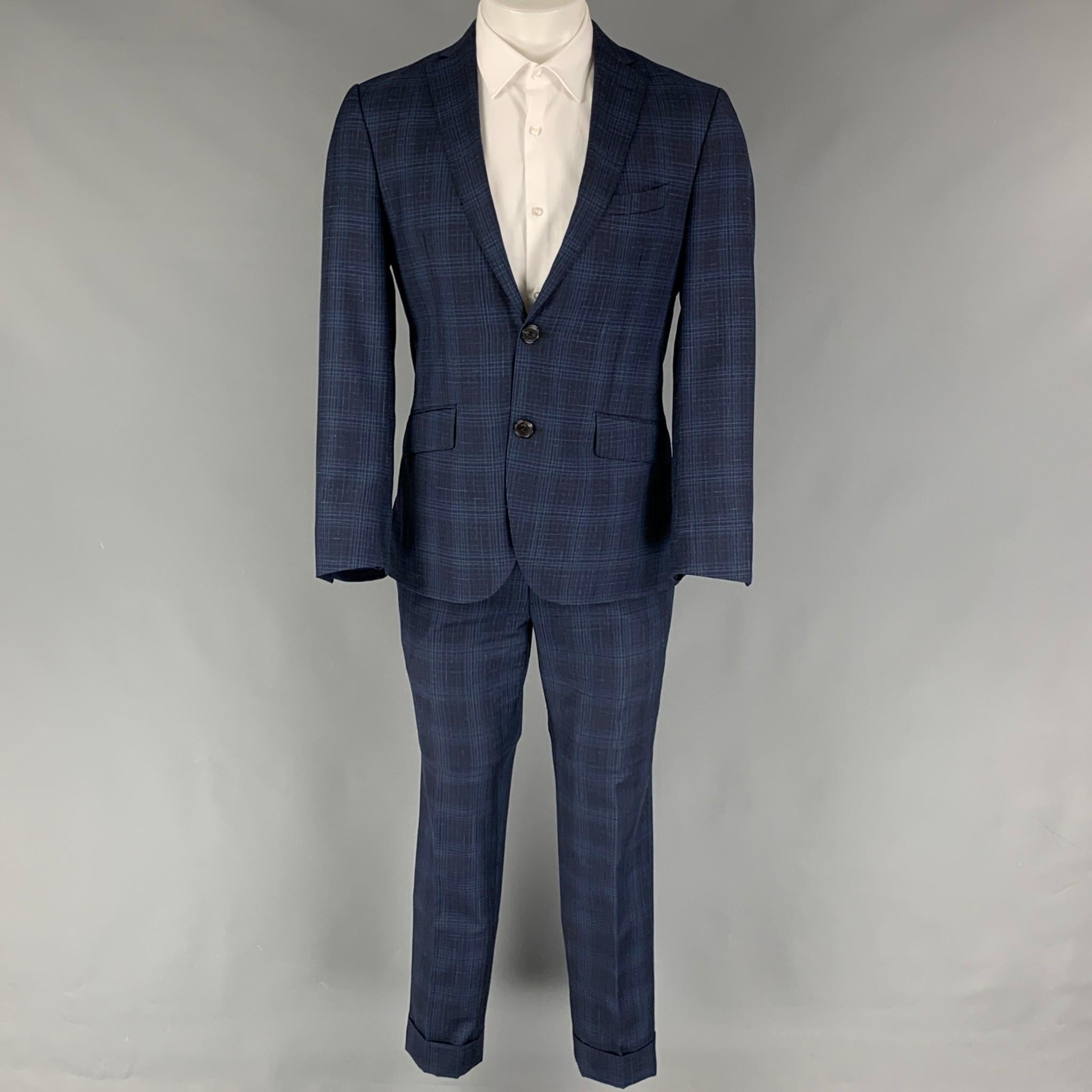 ETRO suit comes in a navy & blue plaid wool blend with a full liner and includes a single breasted, double button sport coat with a notch lapel and matching flat front trousers. Made in Italy.

Excellent Pre-Owned Condition.
Marked:
