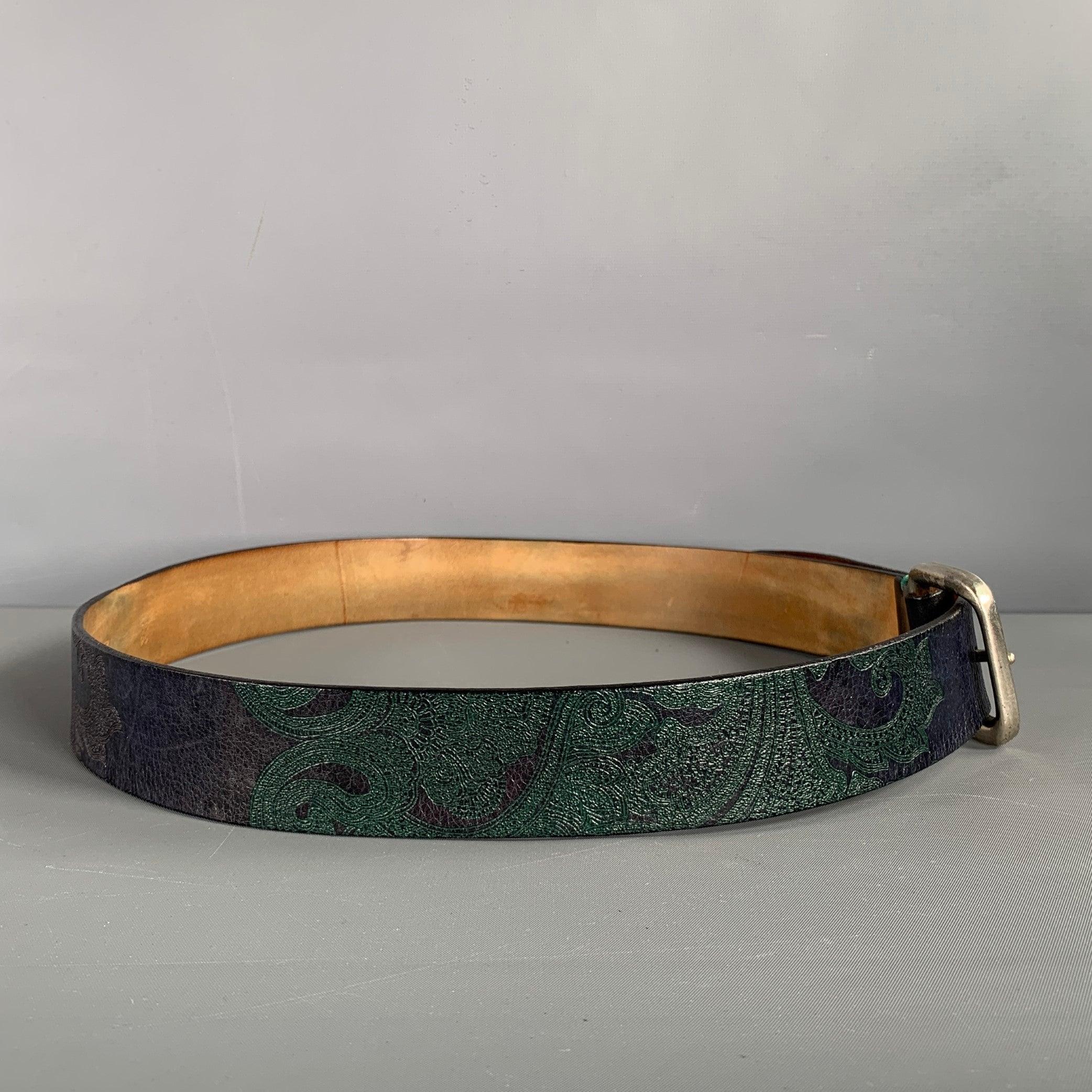 ETRO belt in a navy and green paisley leather featuring a silver tone buckle. Made in Italy.Very Good Pre-Owned Condition. Signs of wear. 

Marked:   95cm. /38 inches Length: 43 inches Width: 1.5 inches Fits: 35 inches  - 38 inches Buckle: 2 inches 