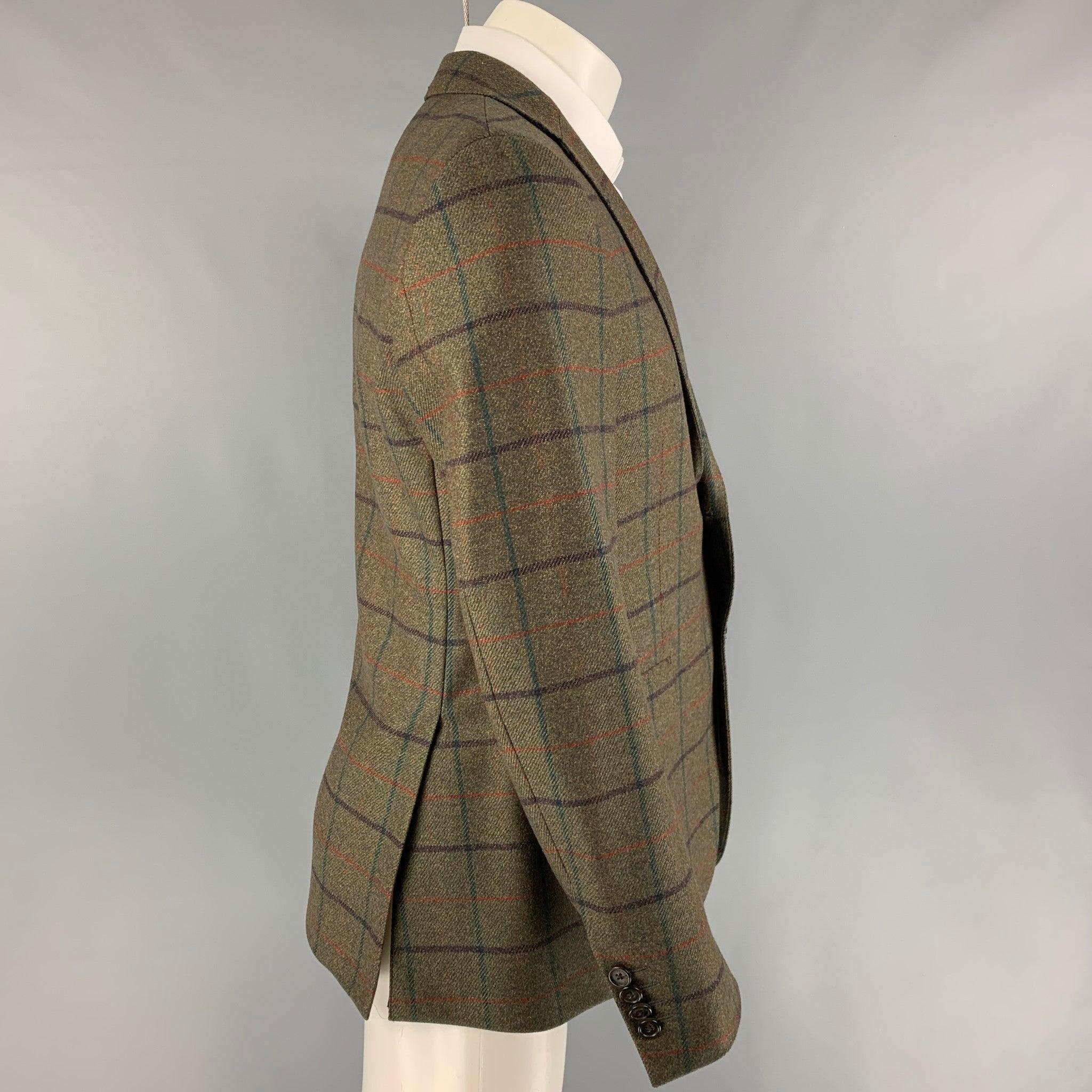 ETRO sport coat comes in a olive window pane wool with a full liner featuring a notch lapel, flap pockets, double back vent, and a double button closure. Made in Italy.
Very Good
Pre-Owned Condition. 

Marked:   48 

Measurements: 
 
Shoulder: 17.5