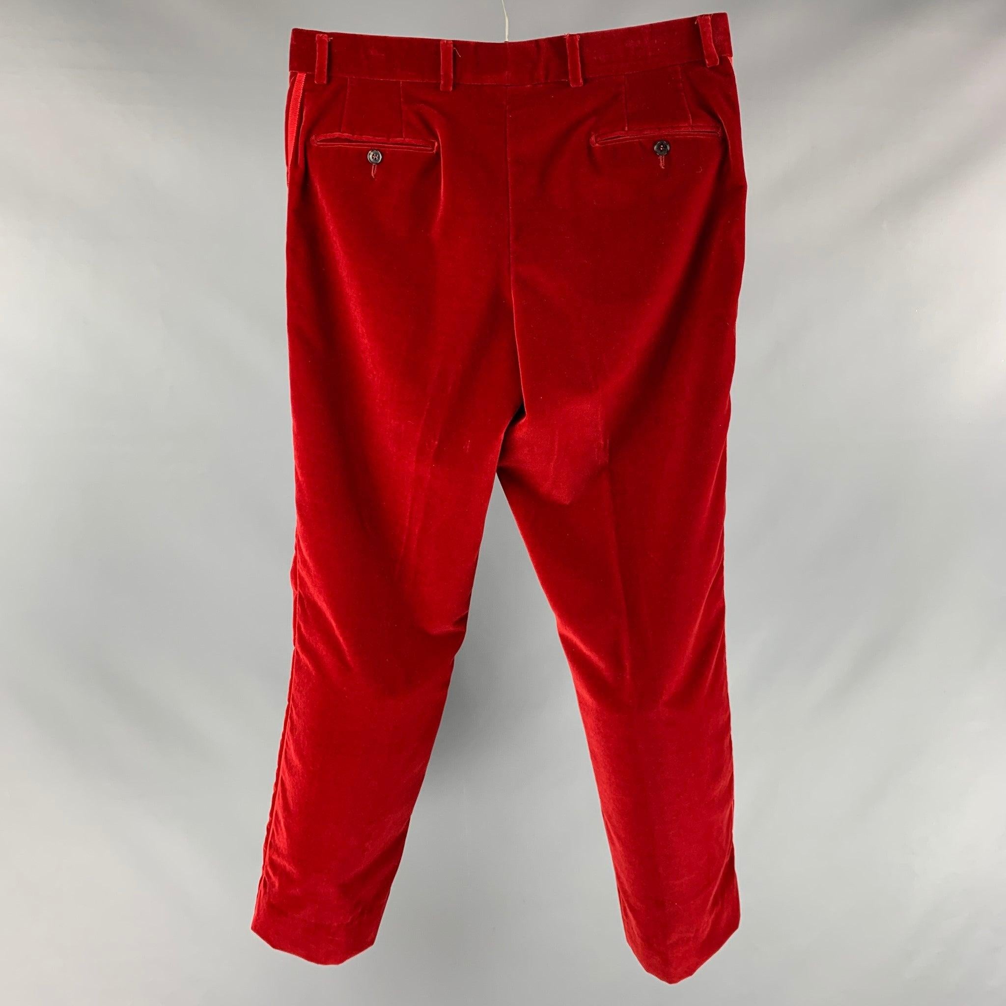 ETRO dress pants comes in a red velvet material featuring a flat front, red gross grain ribbon detail, regular fit, front tab, and a zip fly closure. Made in Italy.Excellent Pre- Owned Condition. 

Marked:  54 

Measurements: 
 Waist: 38 inches