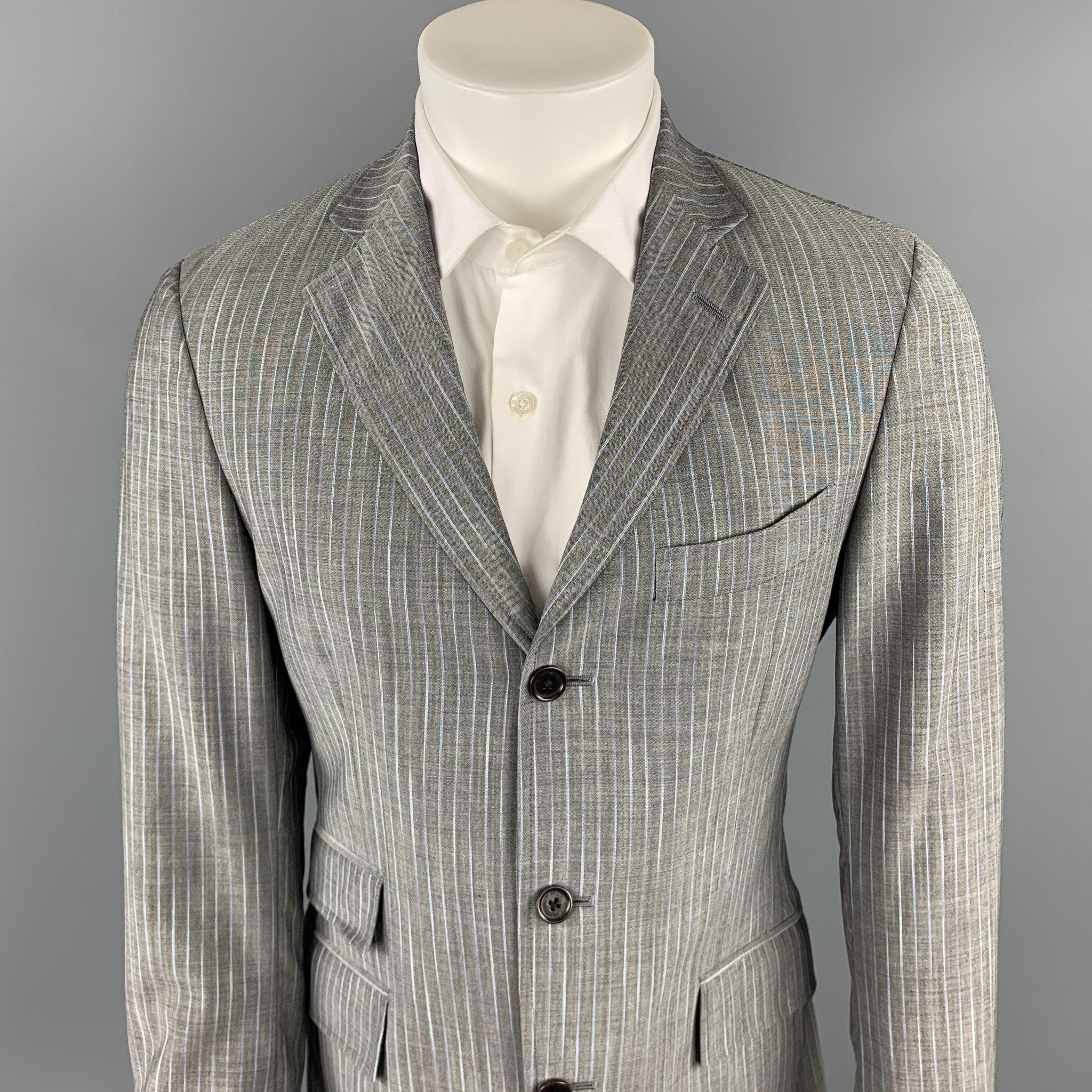 ETRO
suit comes in a gray stripe wool / mohair with a multi-color print liner and includes a single breasted, three button sport coat with a notch lapel and matching
 flat front trousers. 
Made in Italy.New With Tags. 

Marked:   IT 48