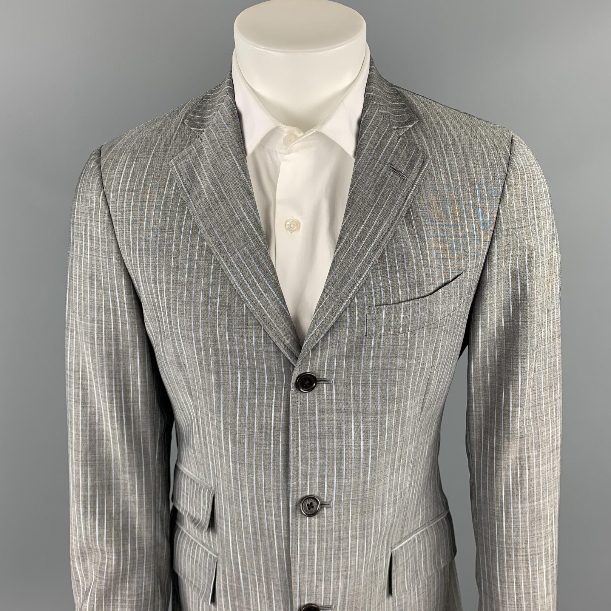 ETRO suit comes in a gray stripe wool / mohair with a multi-color print liner and includes a single breasted, three button sport coat with a notch lapel and matching  flat front trousers.  Made in Italy.

New With Tags.
Marked: IT