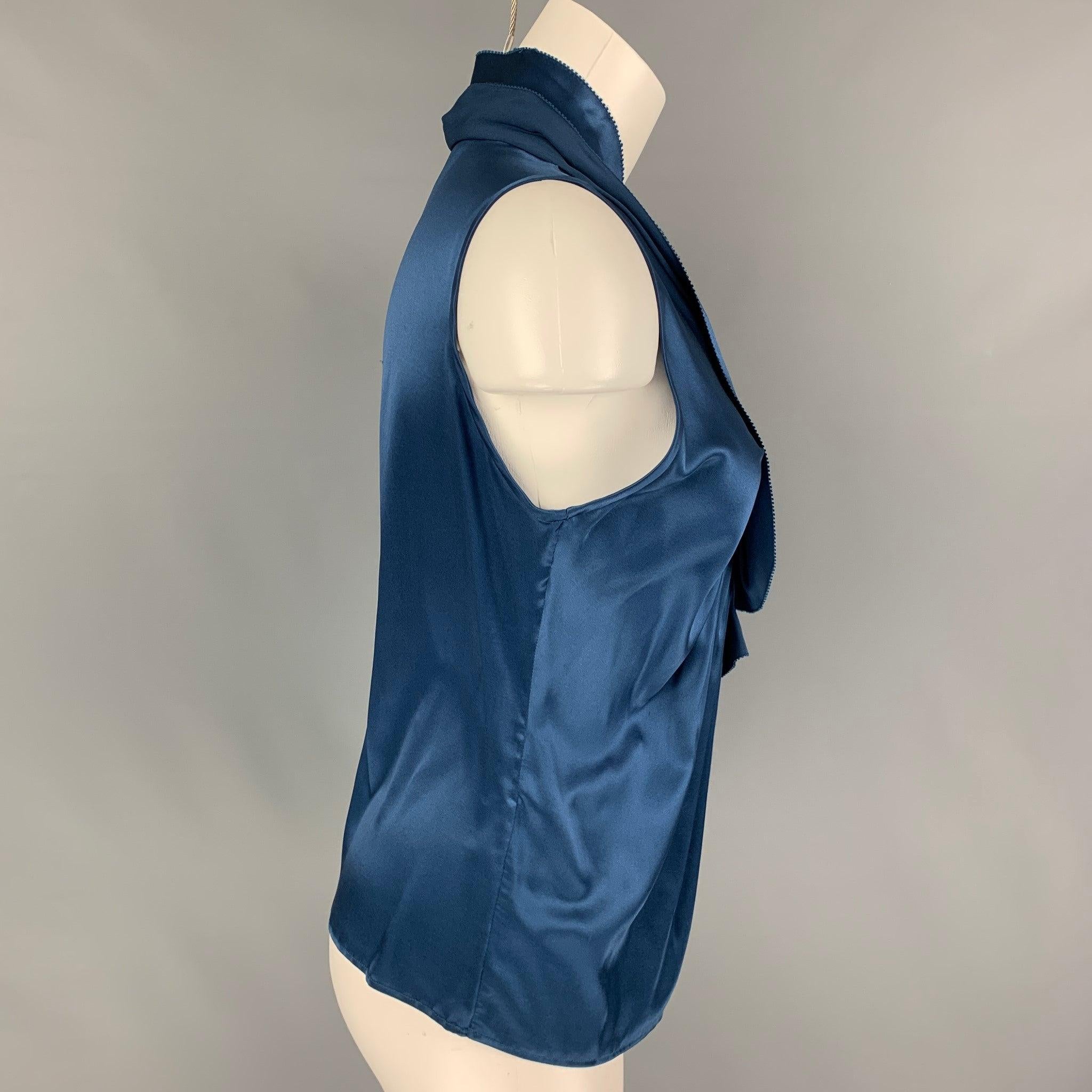 ETRO blouse comes in a blue silk featuring a ruffled design, v-neck, and a sleeveless style. Made in Italy.
Very Good
Pre-Owned Condition. 

Marked:   40 

Measurements: 
 
Shoulder: 12.5 inches  Bust: 28 inches  Length: 21.5 inches 

  
  
