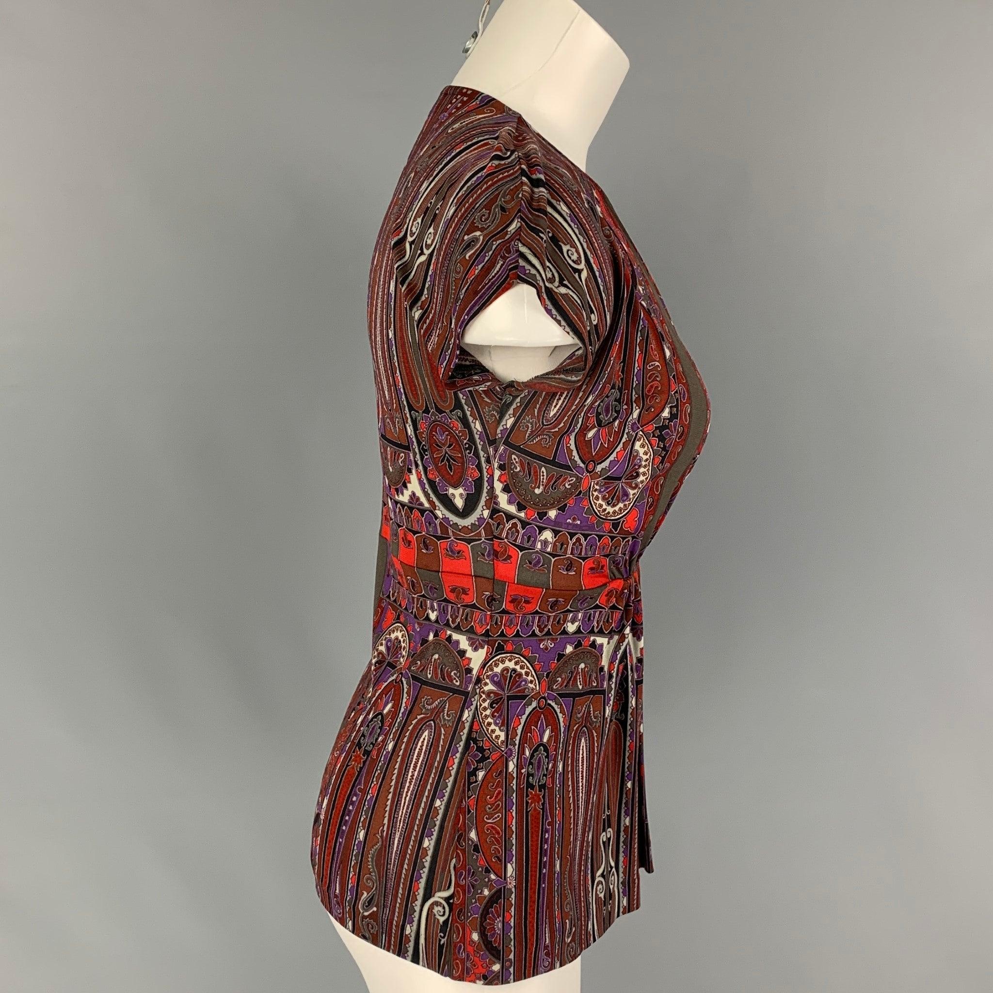 ETRO top comes in a brown & red paisley rayon featuring a elastic detail and a v-neck. Made in Italy.
Very Good
Pre-Owned Condition. 

Marked:   40 

Measurements: 
 
Shoulder: 16 inches  Bust: 30 inches  Sleeve: 2.5 inches  Length: 23 inches 
  
 