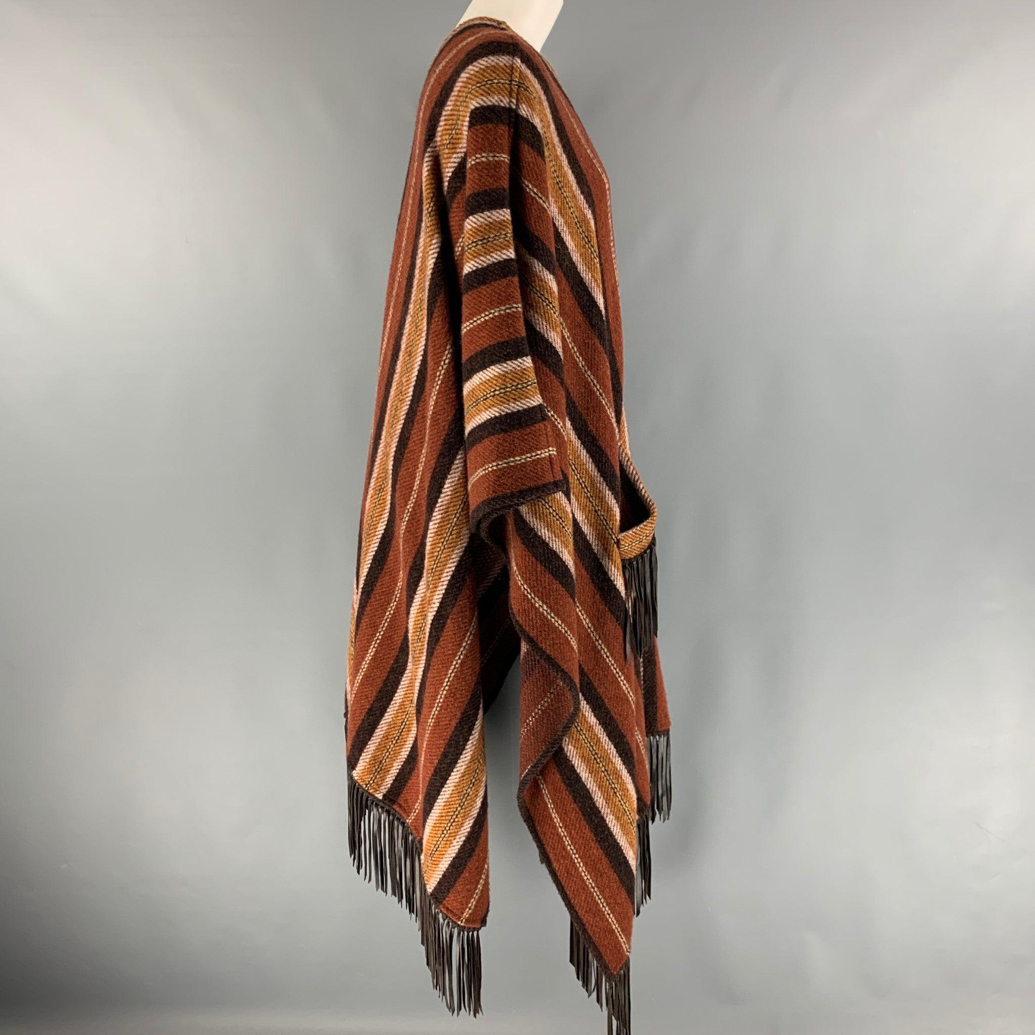 ETRO poncho comes in a brown and tan stripped wool knit featuring boho style, leather fringe trim, and front pockets. Made in Italy.Excellent Pre-Owned Condition. 

Marked:   40 

Measurements: 
  Length: 43 inches  
  
  
 
Reference: