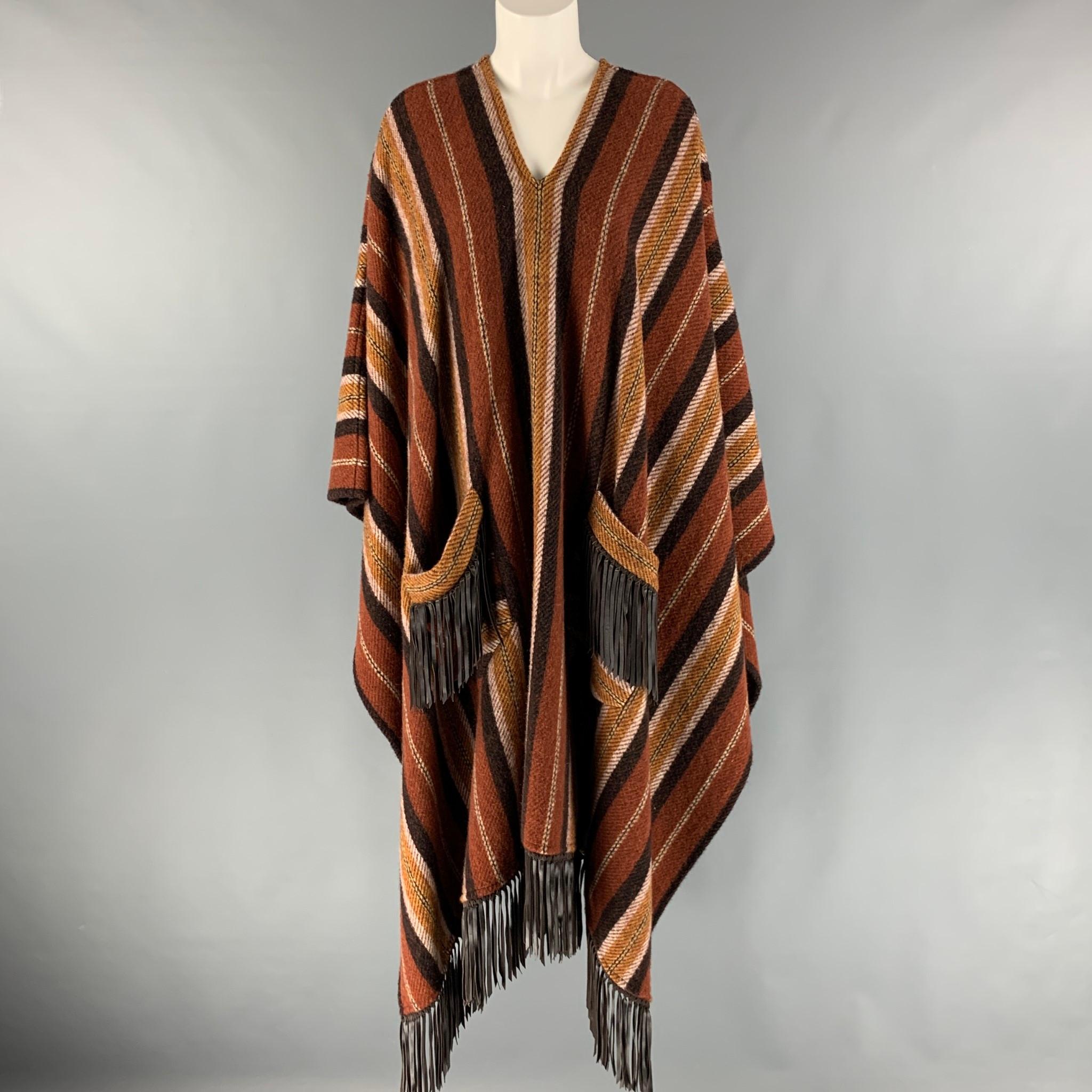 ETRO poncho comes in a brown and tan stripped wool knit featuring boho style, leather fringe trim, and front pockets. Made in Italy.

Excellent Pre-Owned Condition.
Marked: 40

Measurements:

Length: 43 in.  

SKU: 124838
Category: Cape

More