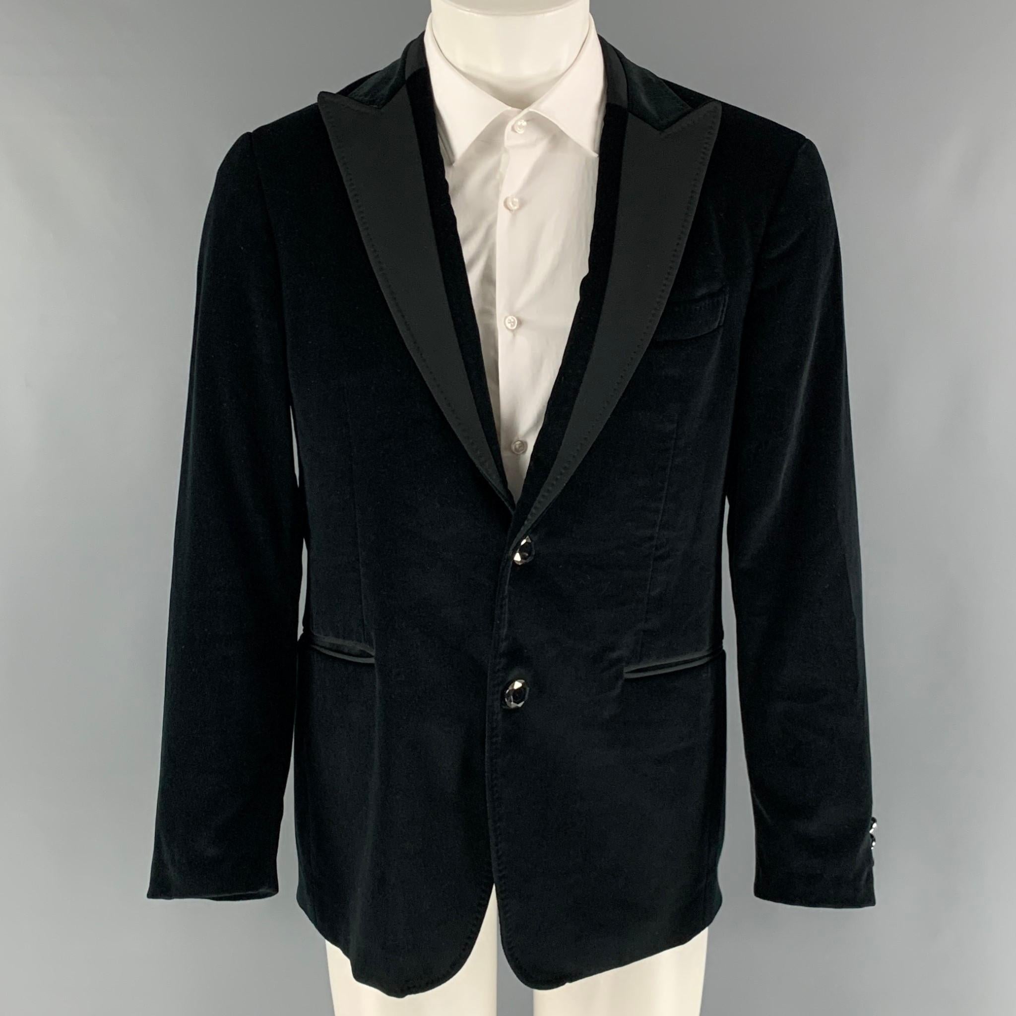 ETRO sport coat comes in black cotton velvet material featuring a peak lapel, single breasted, two button front, and a single back vent. Made in Italy.

Excellent Pre-Owned Condition.
Marked: IT 50

Measurements:

Shoulder: 17.5 in.
Chest: 43