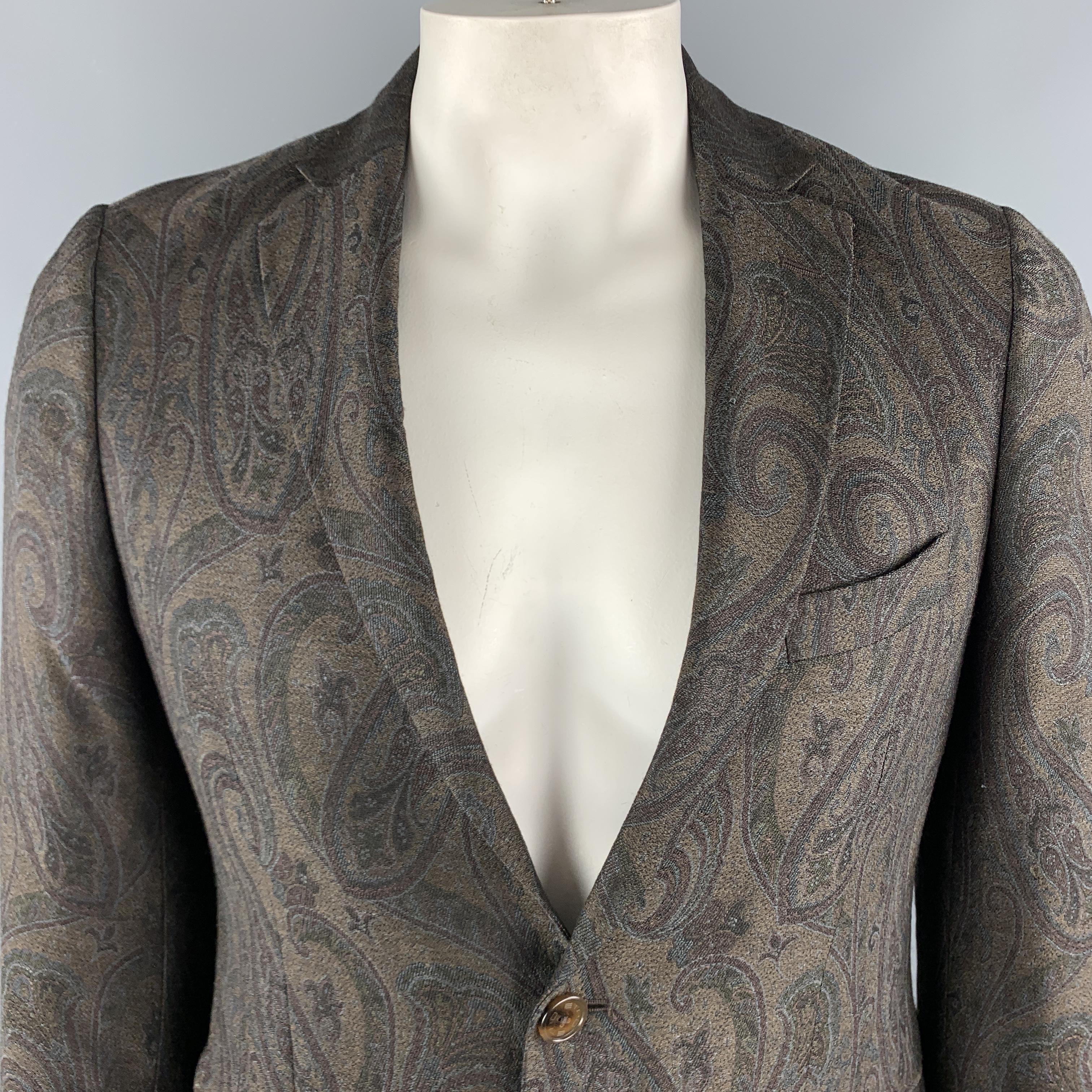 ETRO Sport Coat comes in a brown paisley wool / silk material, with a notch lapel, slit and flap pockets, two buttons at closure, single breasted, buttoned cuffs and a double vent at back. Made in Italy. 

Excellent Pre-Owned Condition.
Marked: IT