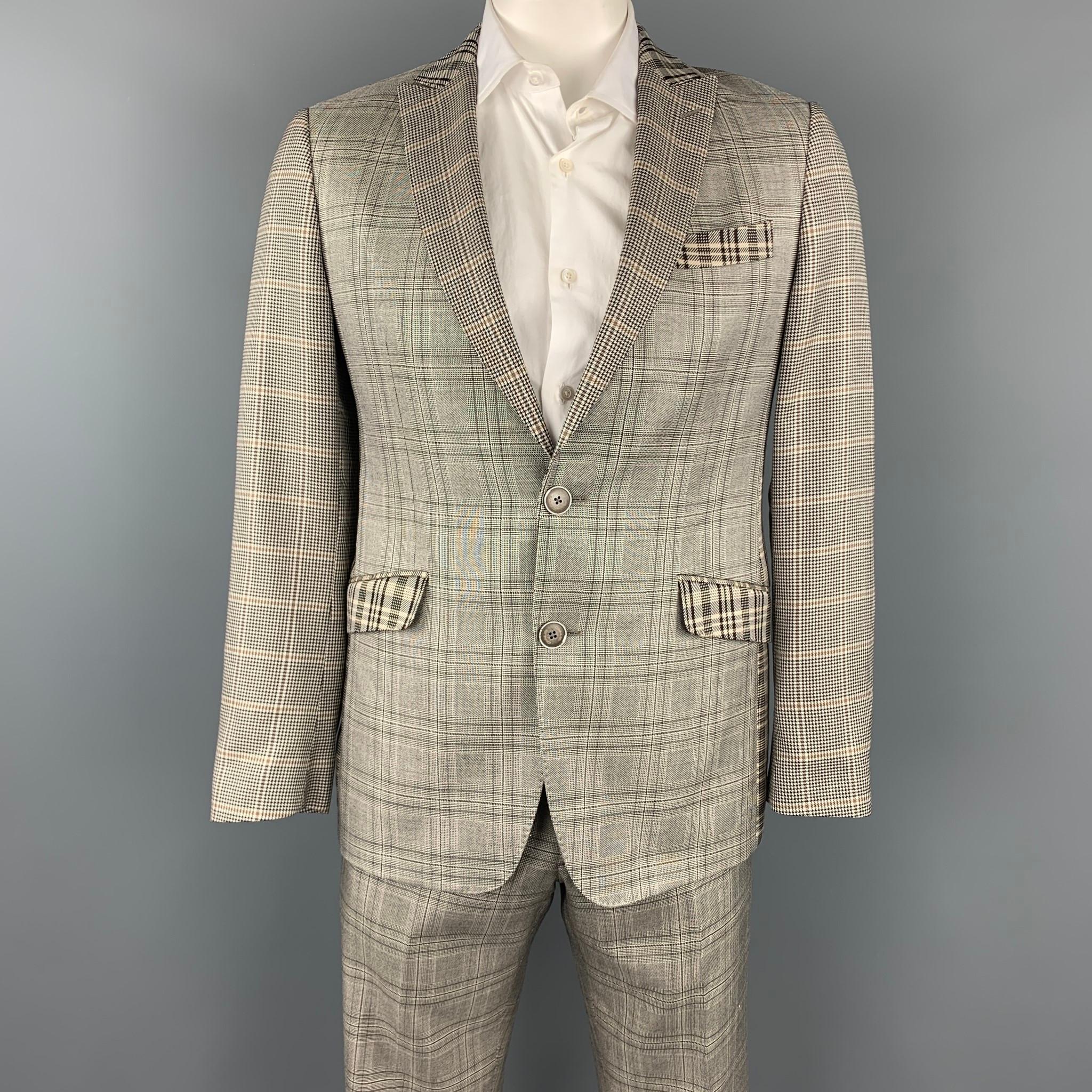 ETRO suit comes in a brown plaid silk / wool with a silk print full liner and includes a single breasted, two button sport coat with a peak lapel and matching flat front trousers. Made in Italy.

Very Good Pre-Owned Condition.
Marked: IT