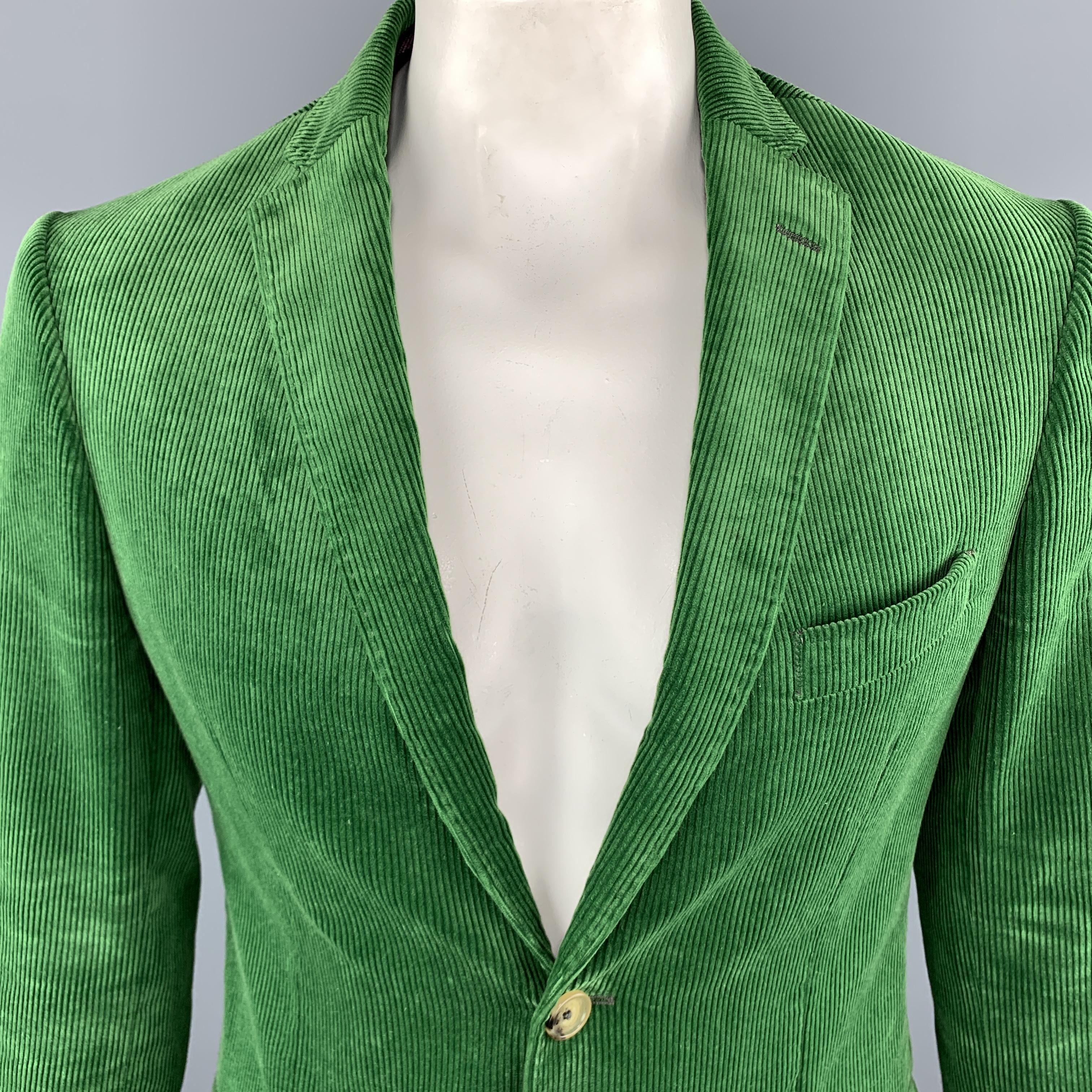 ETRO Sport Coat Jacket comes in a green tone in a corduroy cotton material, with a notch lapel, two buttons at closure, single breasted, slit and flap pockets, buttoned cuffs, and a double vent at back. Made in Italy.

Excellent Pre-Owned