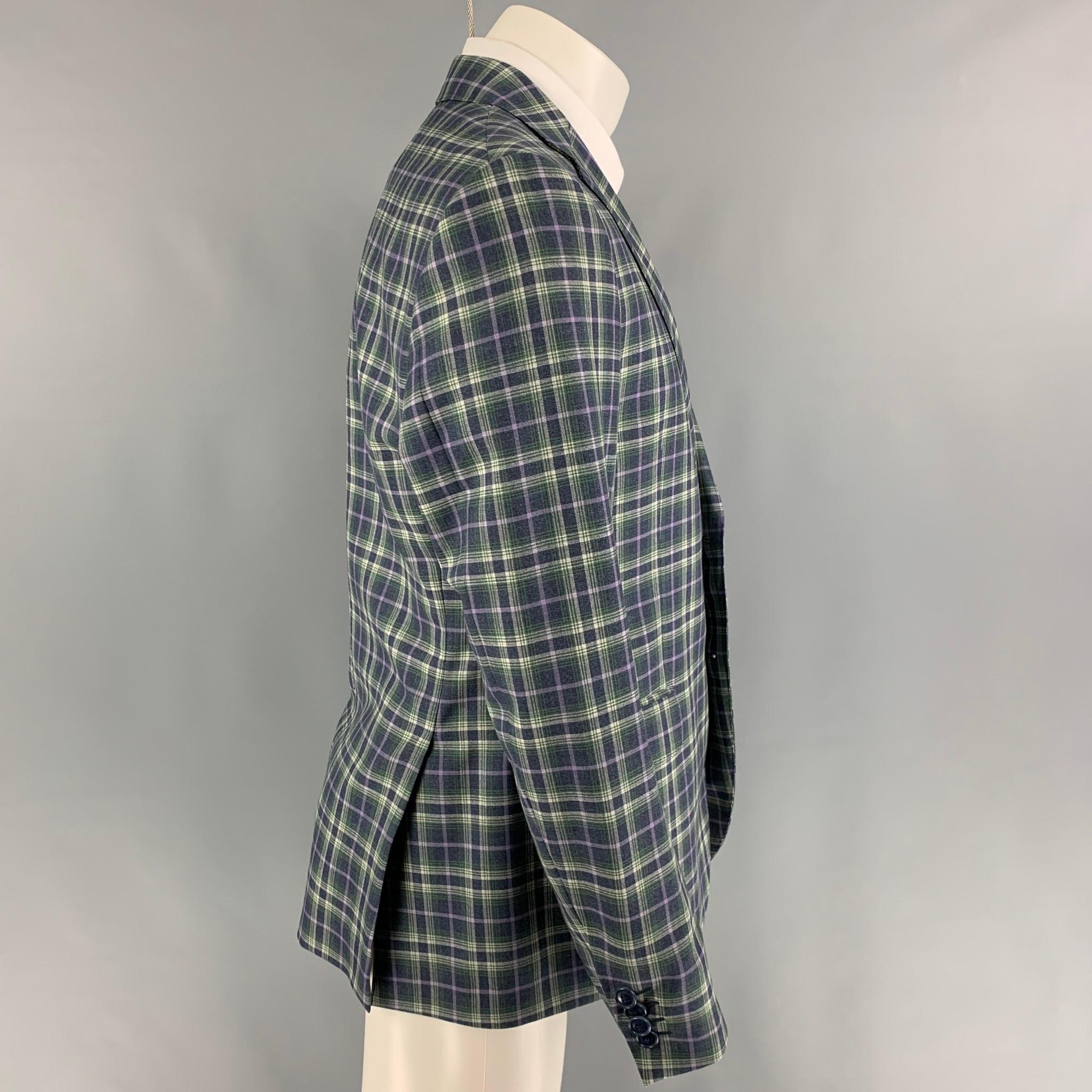 ETRO sport coat comes in a green & purple plaid wool featuring a notch lapel, flap pockets, double back vent, and a two button closure. Made in Italy. 

Very Good Pre-Owned Condition.
Marked: 50

Measurements:

Shoulder: 17.5 in.
Chest: 40