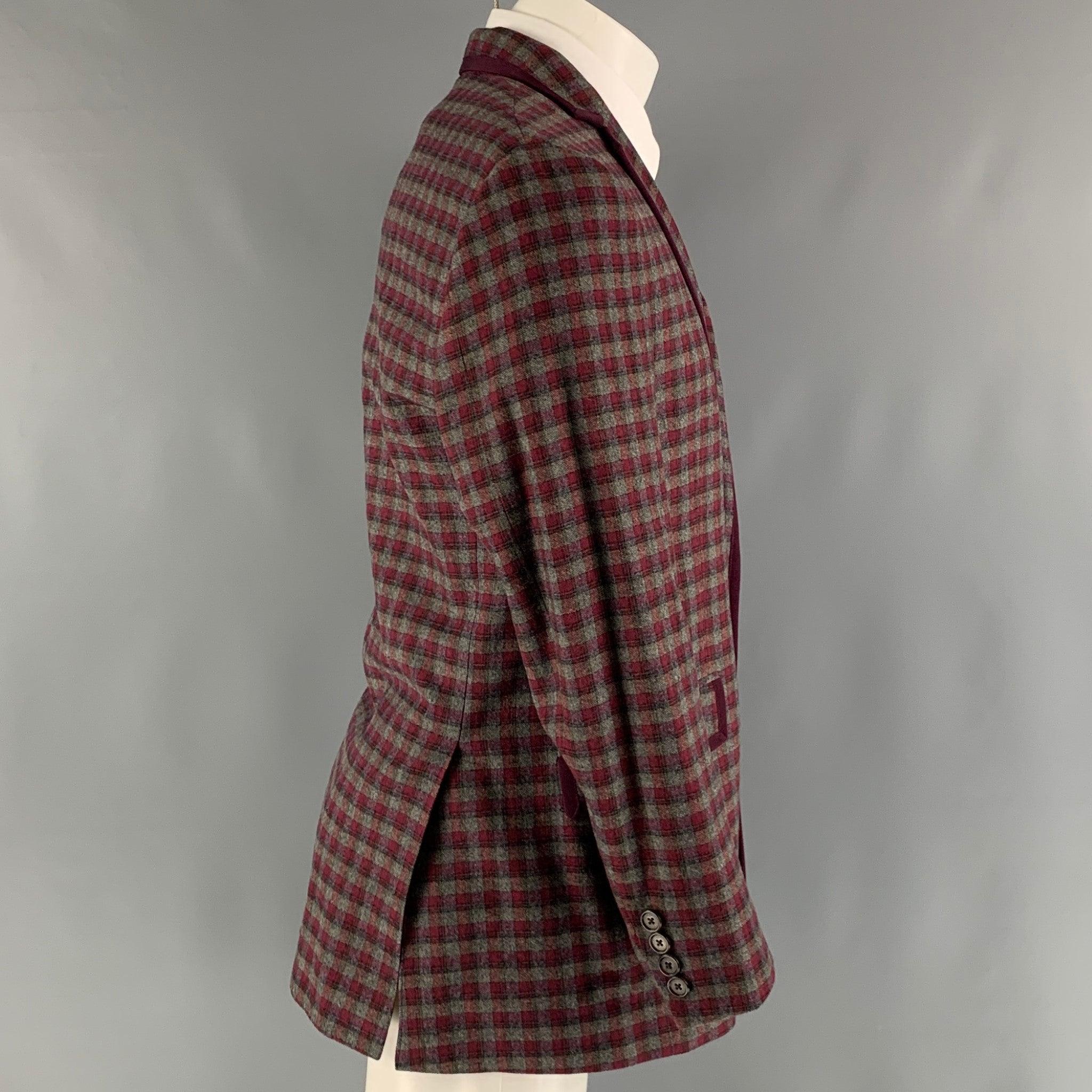 ETRO sport coat comes in a burgundy and grey checkered cotton blend woven material with a full liner featuring a notch lapel, flap pockets, and a two button closure. Made in Italy.Very Good Pre-Owned Condition.
 

Marked:   IT 50 

Measurements: 
