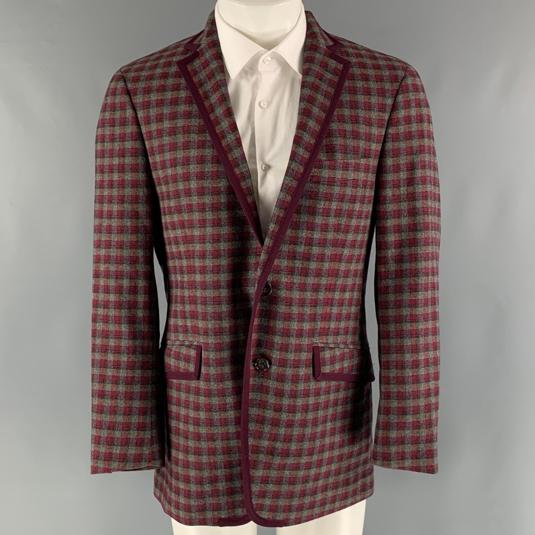 ETRO sport coat comes in a burgundy and grey checkered cotton blend woven material with a full liner featuring a notch lapel, flap pockets, and a two button closure. Made in Italy.

Very Good Pre-Owned Condition. 
Marked: IT