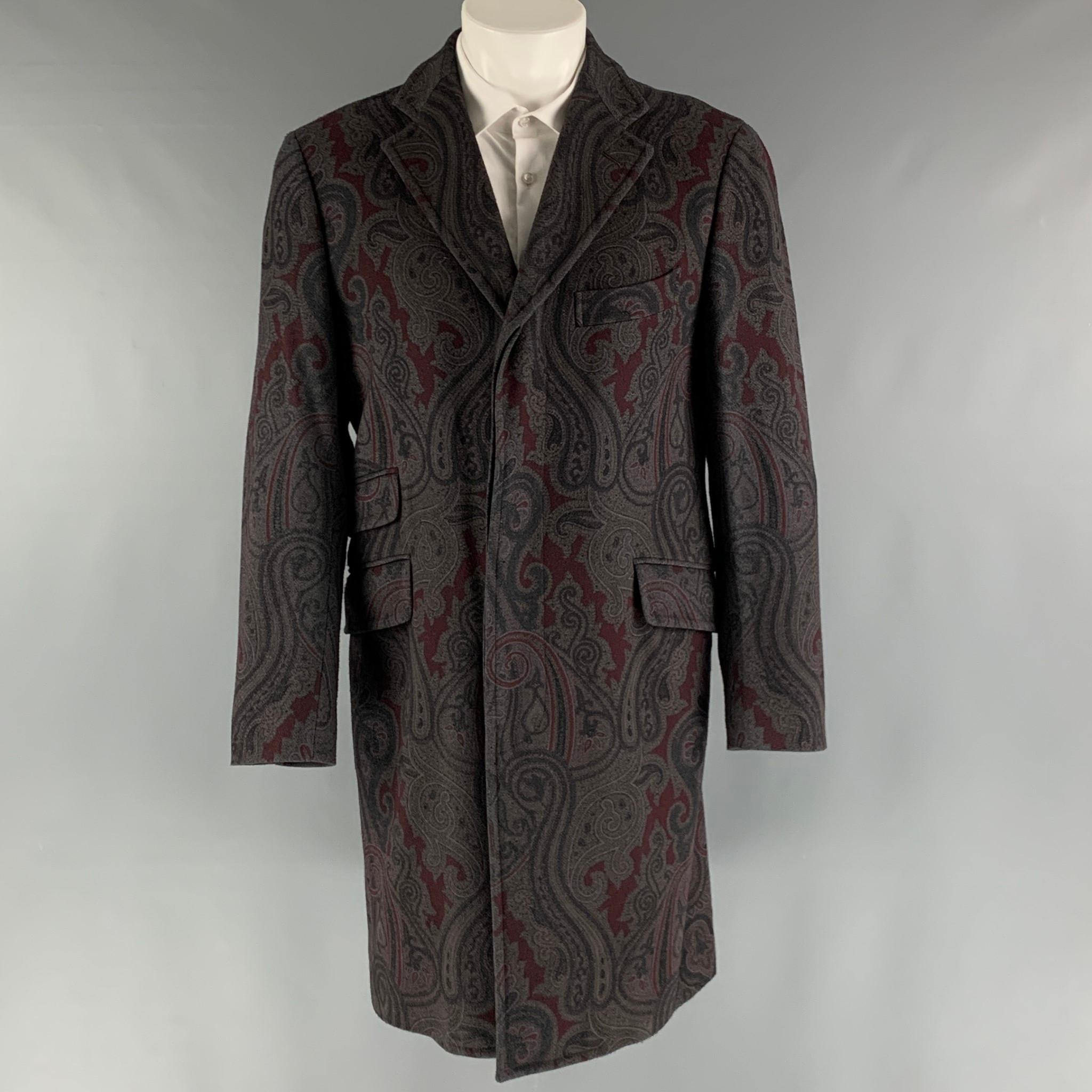 ETRO coat comes in a grey and burgundy wool and polyamide woven material with a full liner featuring a paisley motif, notch lapel, flap pockets, single back vent, and a button closure. Made in Italy.

Excellent Pre-Owned Condition.
Marked:
