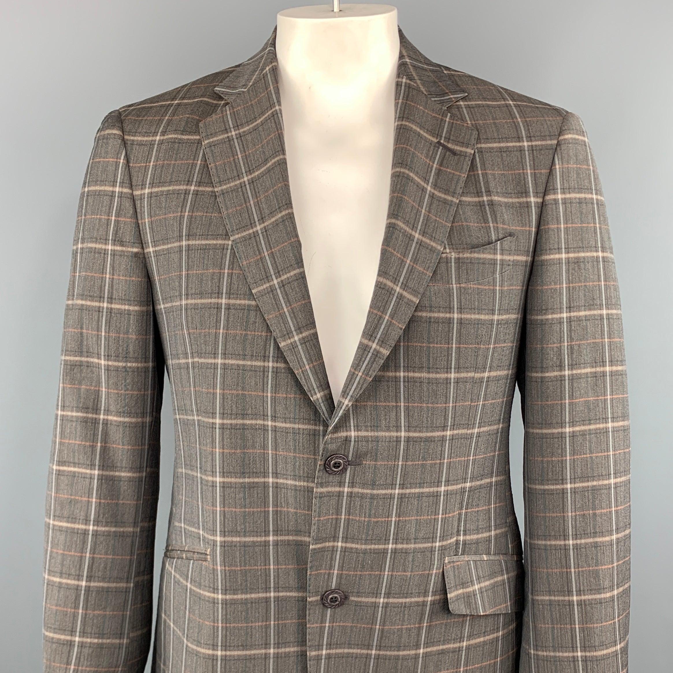 ETRO sport coat comes in a gray plaid wool and elastane featuring a notch lapel style, two button closure, and front flap pockets. Made in Italy.Excellent Pre-Owned Condition. 

Marked:   50 

Measurements: 
 
Shoulder: 17 inches  Chest: 39 inches 