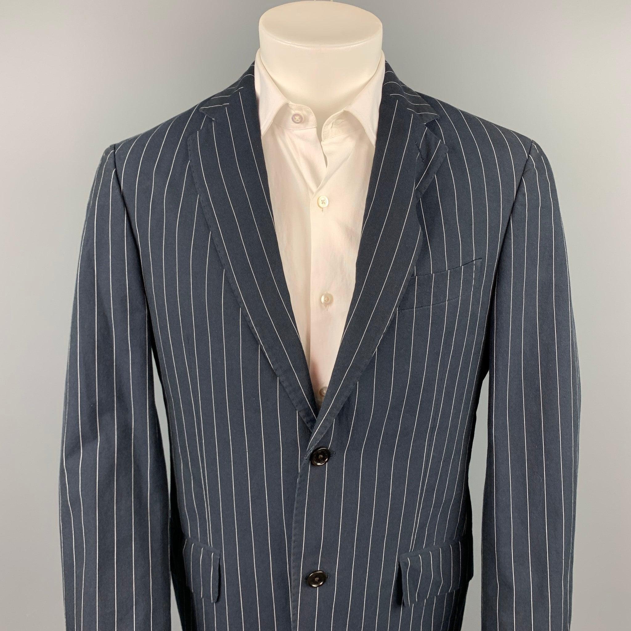 ETRO sport coat comes in a navy pinstripe cotton with a half print liner featuring a notch lapel, flap pockets, and a two button closure. Made in Italy.Very Good
Pre-Owned Condition. 

Marked:   IT 50 

Measurements: 
 
Shoulder:
18.5 inches  Chest: