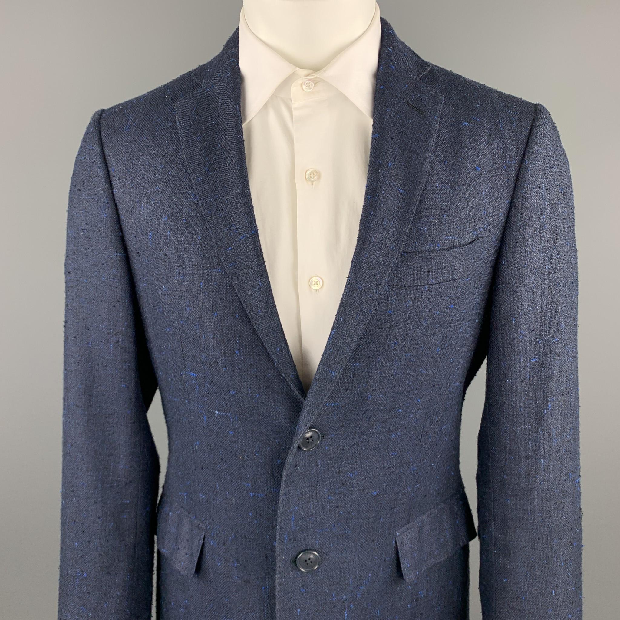 ETRO sport coat comes in a navy textured silk / linen featuring a notch lapel, paisley print liner, flap pockets, and a two button closure. Made in Italy.

Excellent Pre-Owned Condition.
Marked: IT 50

Measurements:

Shoulder: 17 in.
Chest: 40 in.