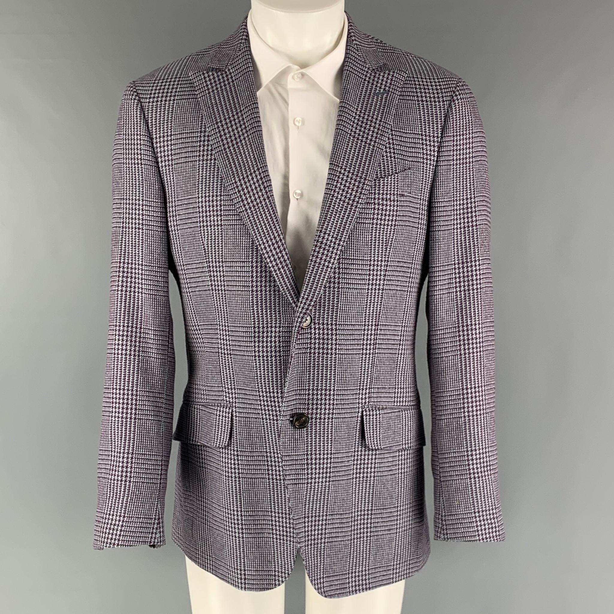 ETRO sport coat comes in a purple and blue plaid cotton and silk woven material with a full lining featuring a peak lapel, flap pockets, double back vent, and a two button closure. Made in Italy.

Excellent Pre-Owned Condition.
Marked: IT