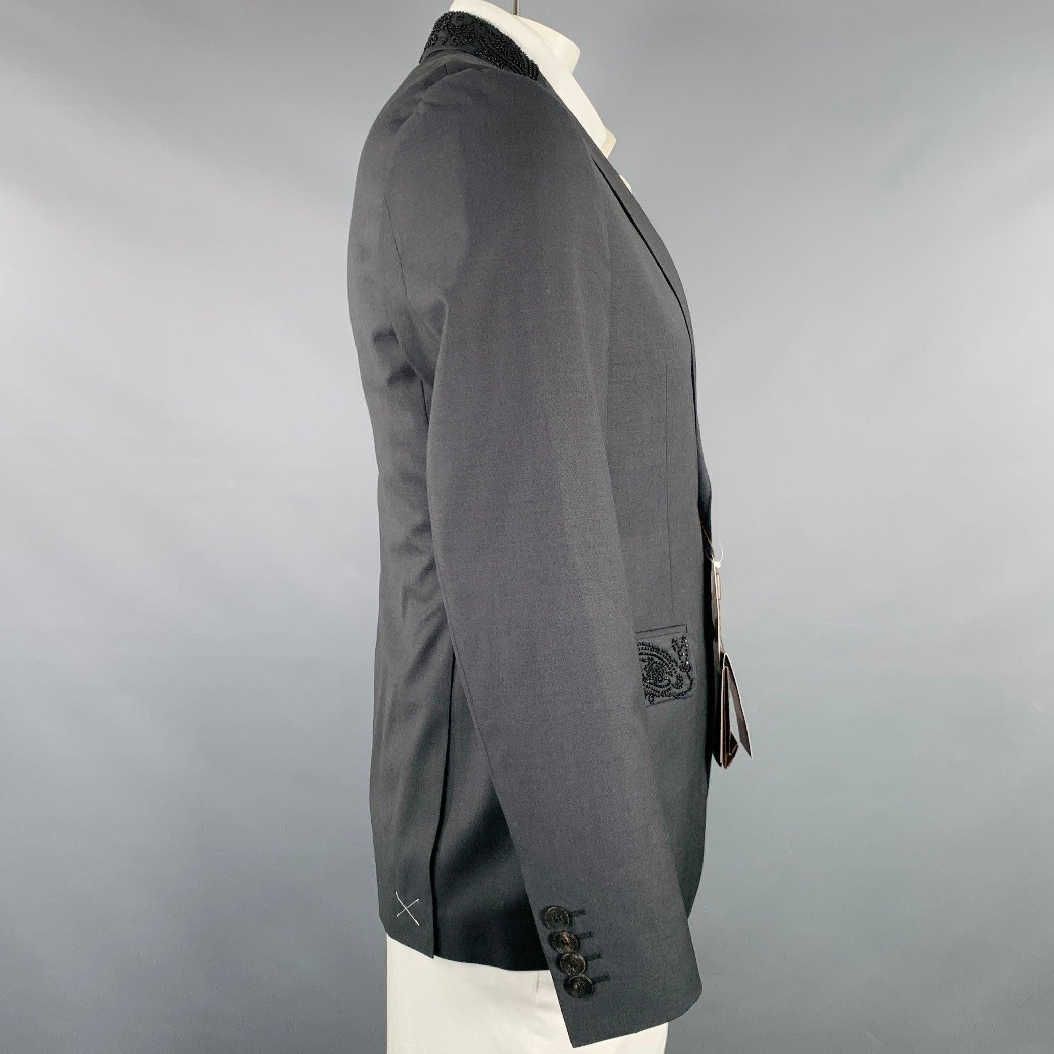 ETRO sport coat
in a black wool featuring a beaded notch lapel with beaded pocket trim details, double vented back, and double button closure. Made in Italy.New with Tags. 

Marked:   IT 52 

Measurements: 
 
Shoulder: 17 inches Chest: 42 inches