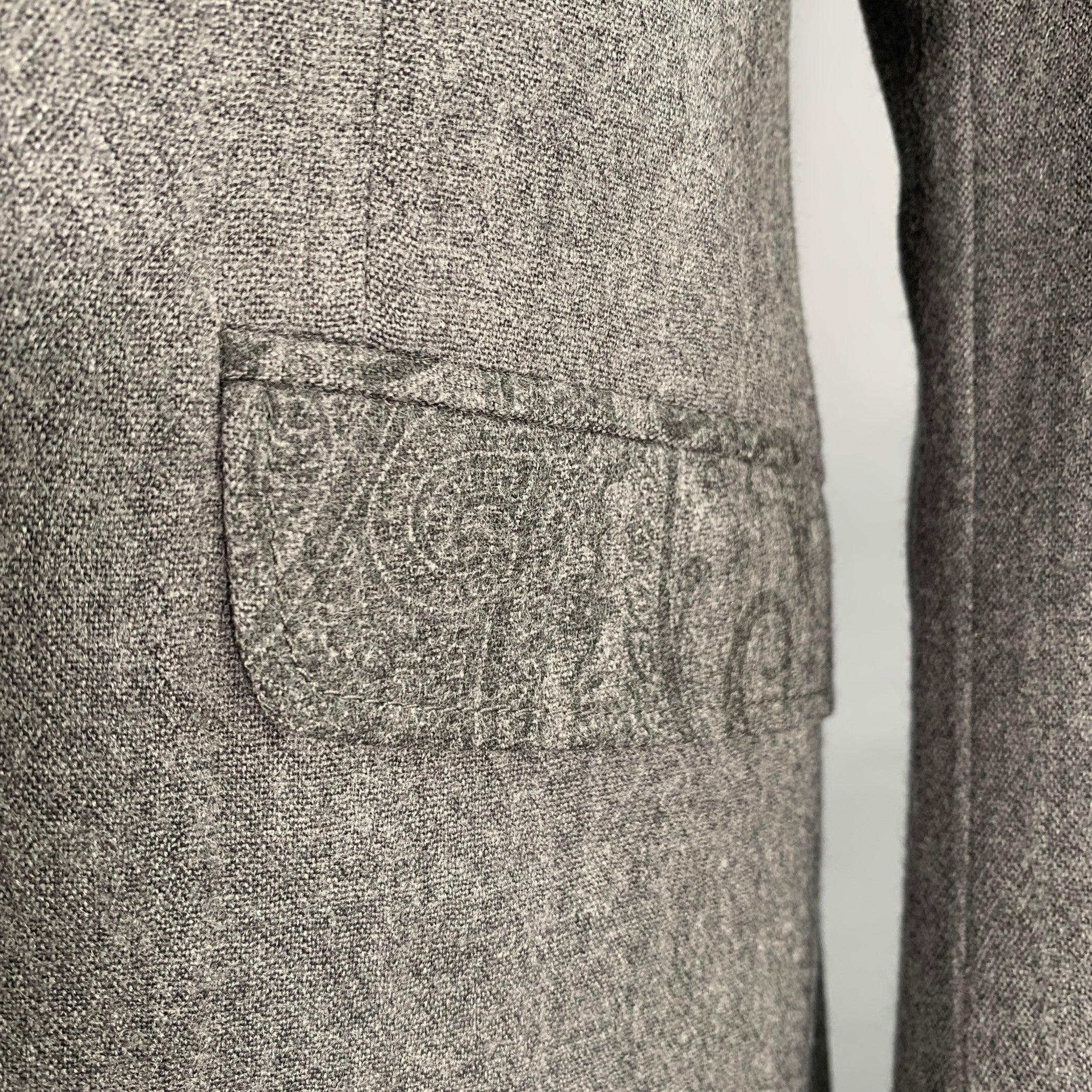 ETRO sport coat
in a grey wool blend fabric featuring a paisley trim at pockets and collar, notch lapel, double vented back, and double button closure. Made in Italy.Excellent Pre-Owned Condition. 

Marked:   IT 52 

Measurements: 
 
Shoulder: 17