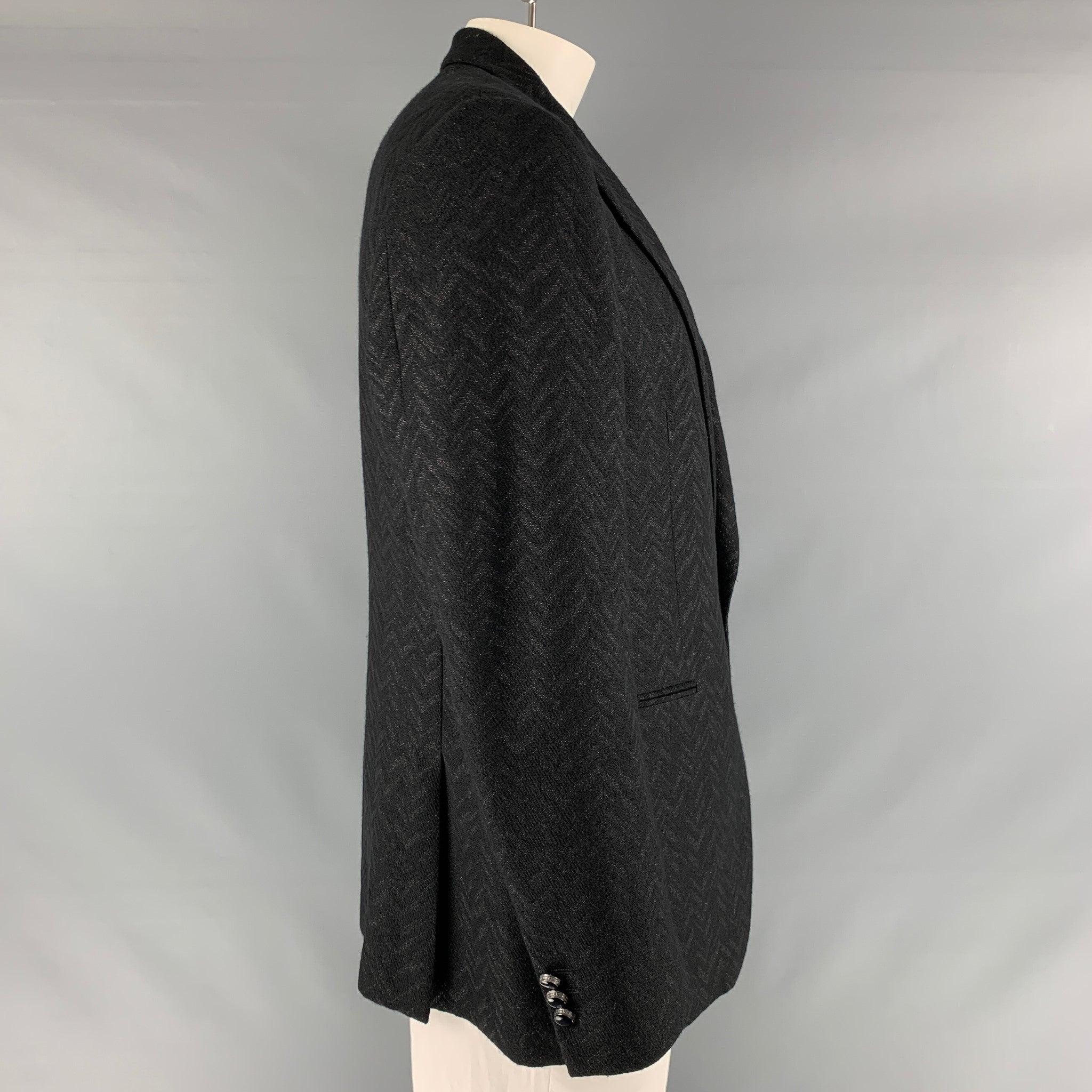 ETRO sport coat comes in a black novelty metallic chevron wool blend woven material with a full liner featuring a peak collar, welt pockets, and a single button closure. Made in Italy.Excellent Pre-Owned Condition. 

Marked:   IT 54 

Measurements: