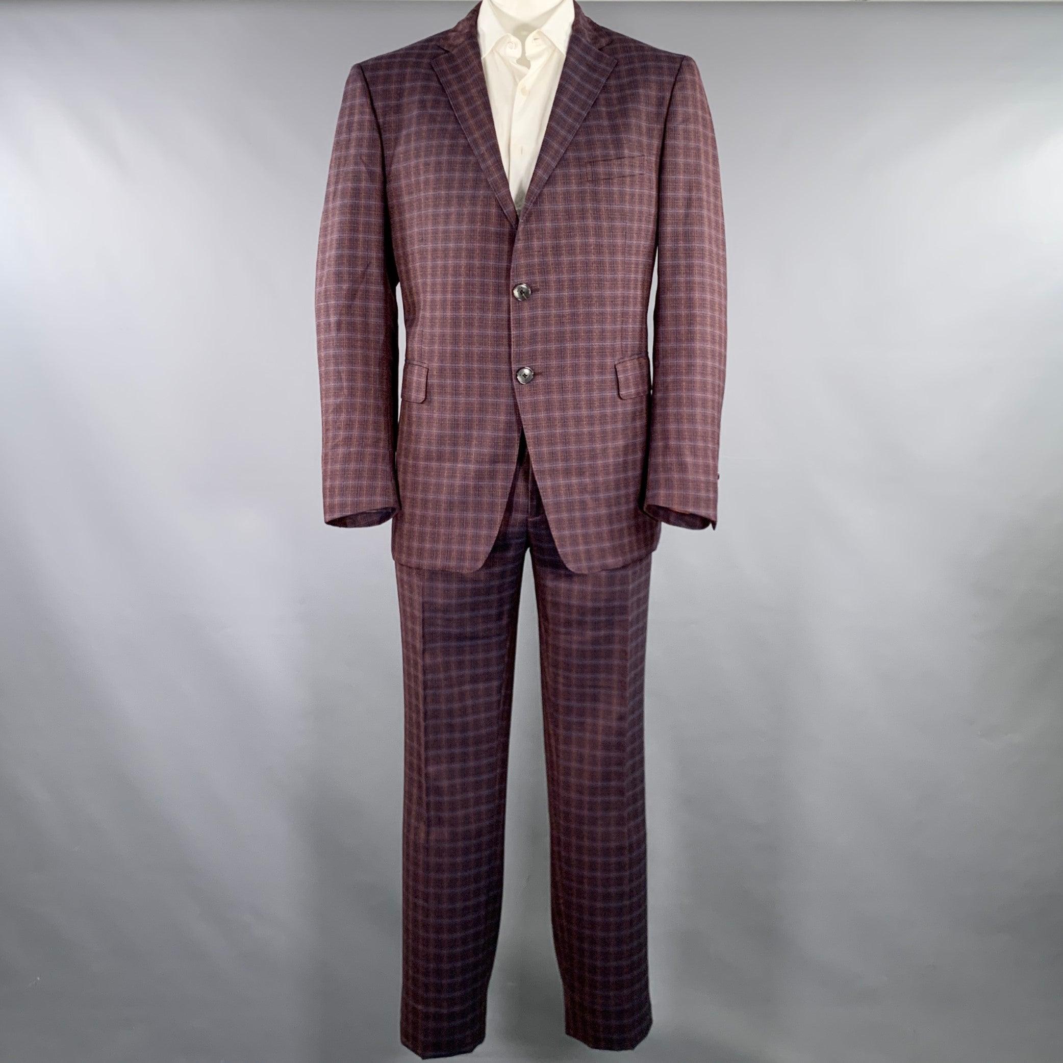 ETRO suit
in a burgundy, black, and gold plaid wool with a full liner and includes a single breasted, double button sport coat with a notch lapel and matching flat front trousers. Made in Italy.Excellent Pre-Owned Condition. 

Marked:   IT 58