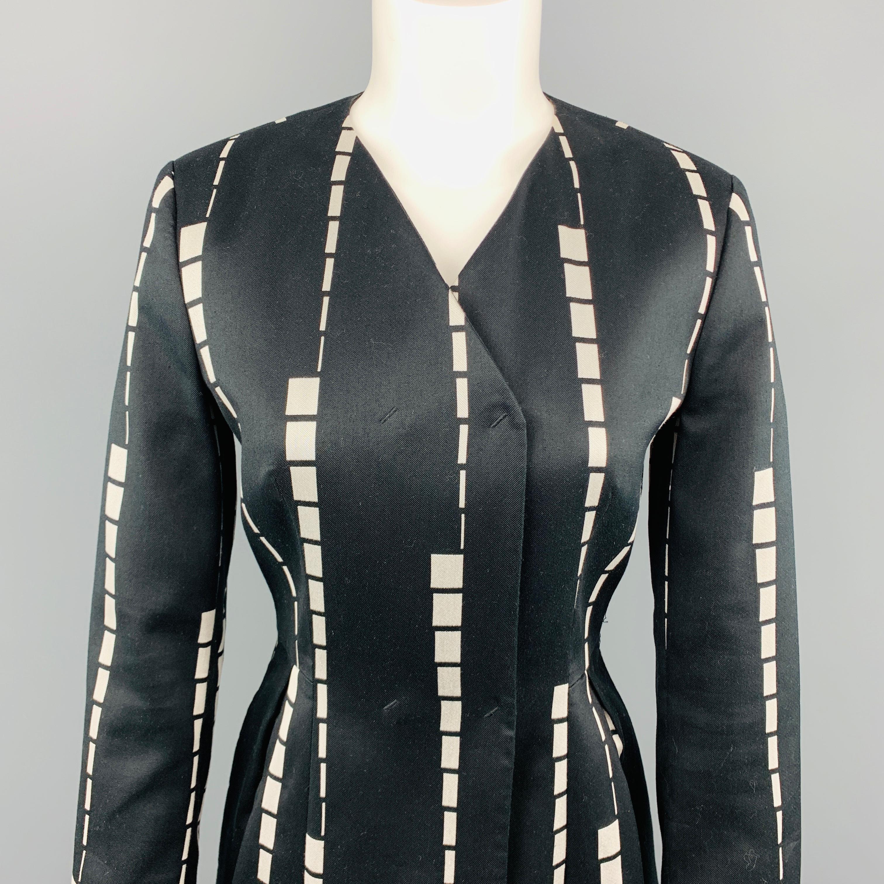 ETRO coat comes in black twill with cream geometric stripe pattern and features a collarless V neck, double breasted, hidden snap closures, and pleated front skirt bottom. Made in Italy.
 
Excellent Pre-Owned Condition.
Marked: IT 42
