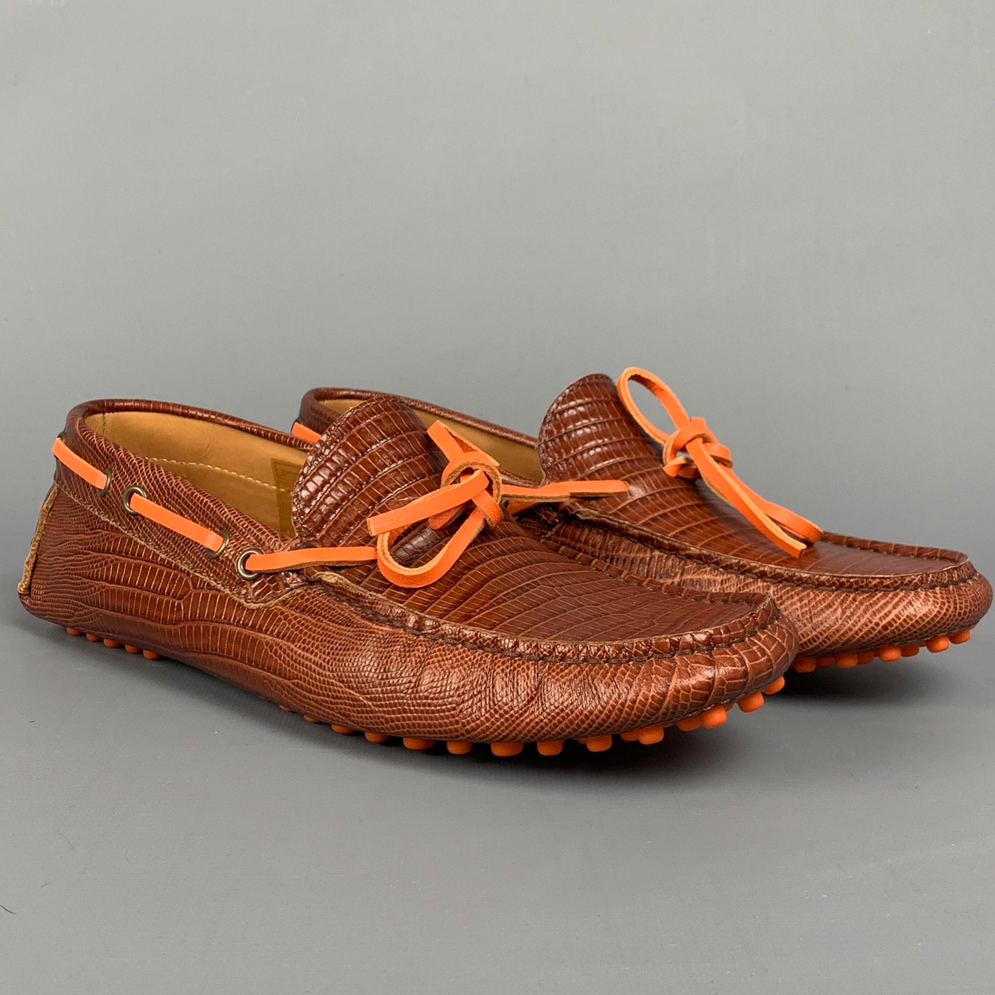 ETRO loafers comes in a cognac embossed leather featuring a drivers style, square toe, and a orange strap closure. Made in Italy.

Very Good Pre-Owned Condition.
Marked: EU 41

Outsole: 3.5 in. x 10.5 in. 