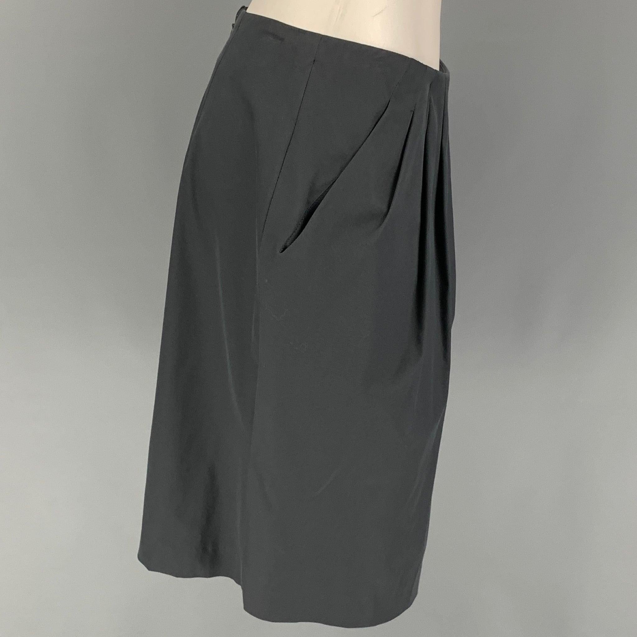 ETRO skirt comes in a slate cotton featuring a pleated style, slit pockets, and a back zip up closure.
New with tags.
 

Marked:   42 

Measurements: 
  Waist: 28 inches  Hip: 42 inches  Length: 22 inches 
  
  
 
Reference: 121714
Category: