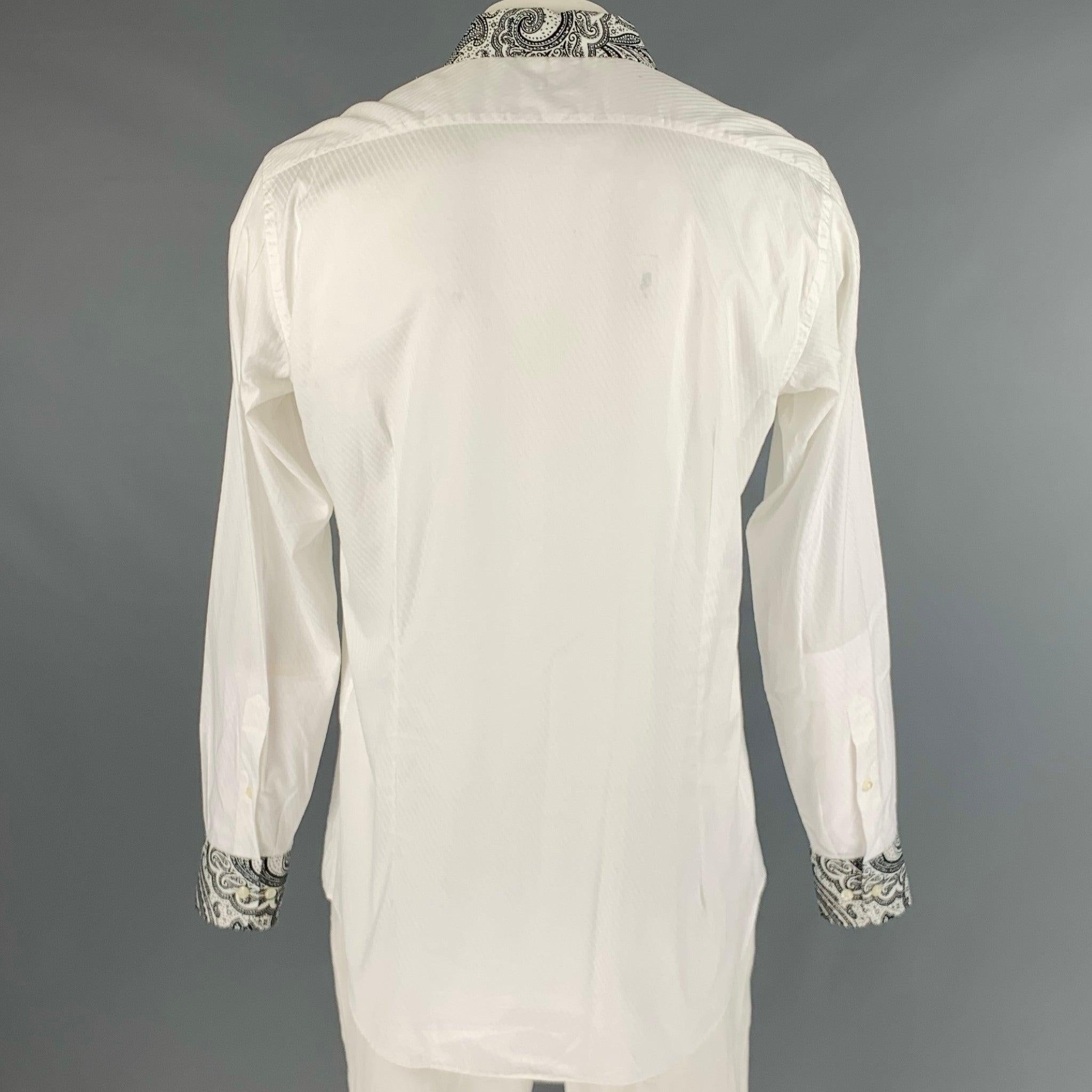 ETRO long sleeve shirt
in a
white cotton fabric featuring diagonal stripe pattern, contrast collar and cuffs with black paisley print, and a button closure. Made in Italy.Very Good Pre-Owned Condition. Marks inside of collar, and minor mark on